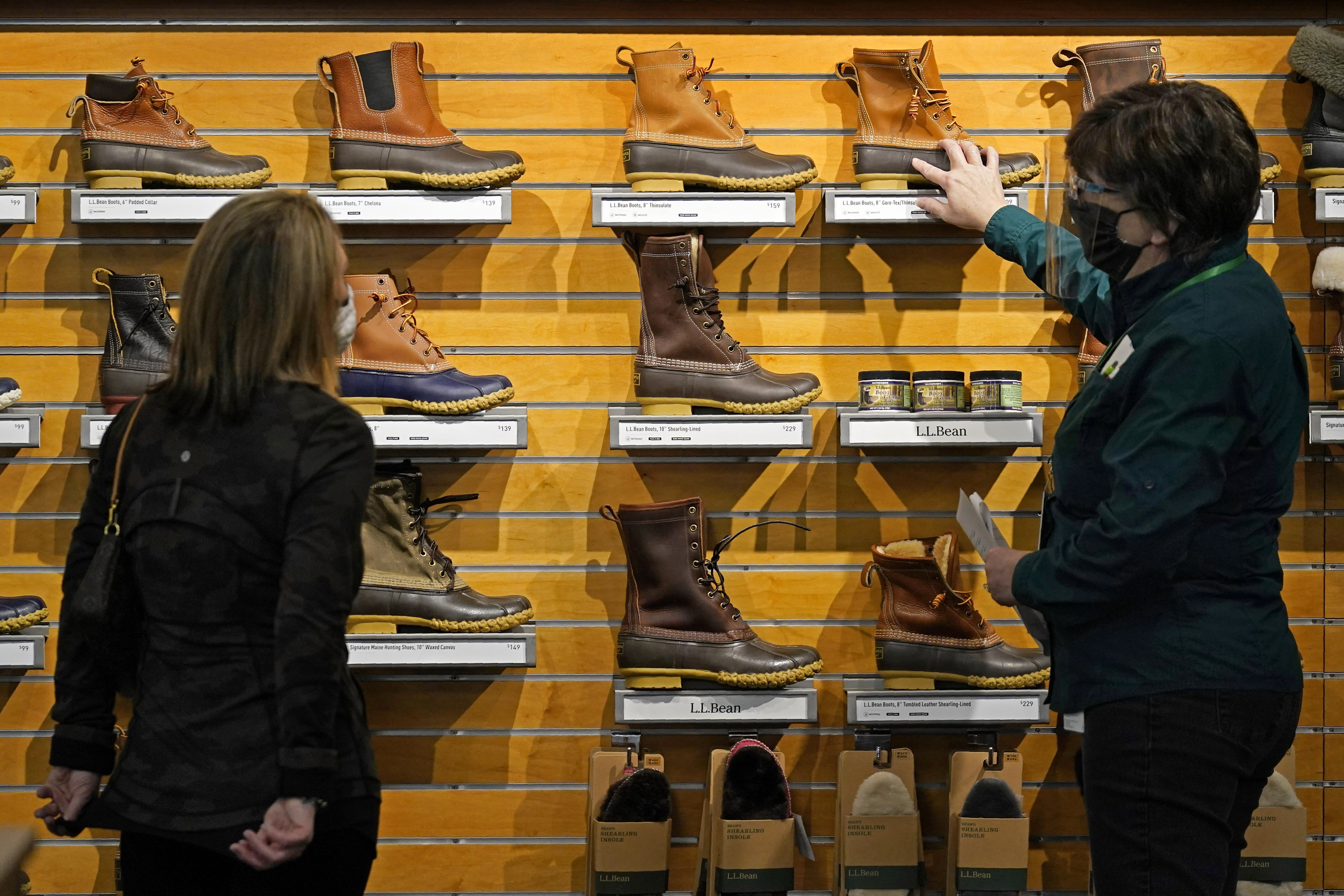 A salesperson helps a customer at the L.L. Bean flagship retail store in Freeport, Maine, US, on March 18. US household incomes rose by the most in recorded history in March. Photo: AP