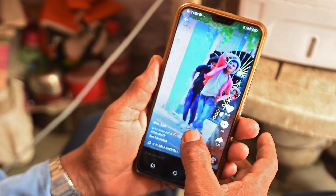 This illustration photo taken on June 30, 2020 shows a person using the Chinese video app Tik Tok on a smartphone in India. Photo: AFP