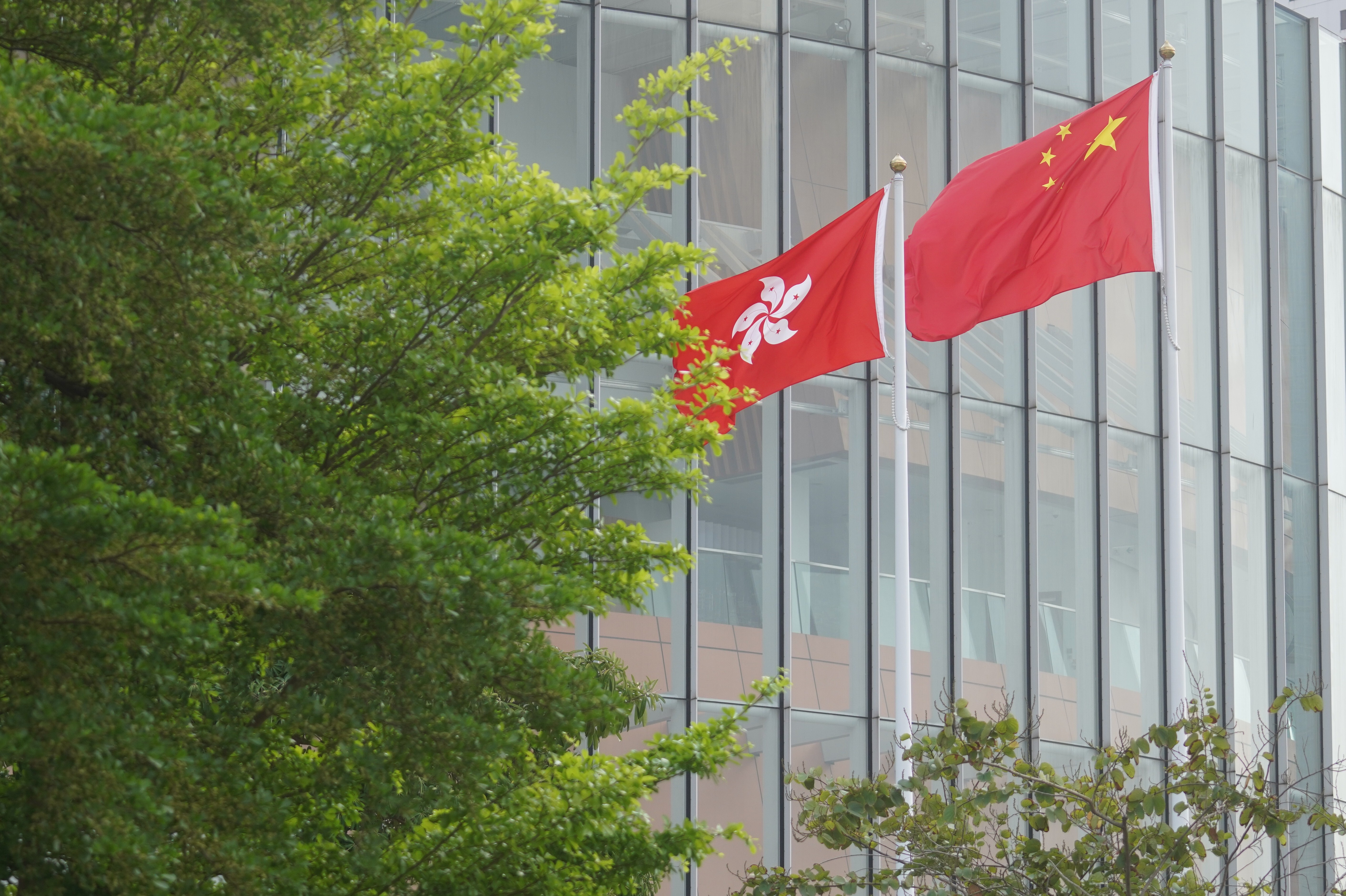 The flags of Hong Kong and China fly outside the Legislative Council building in Admiralty, on March 30. Photo: Winson Wong