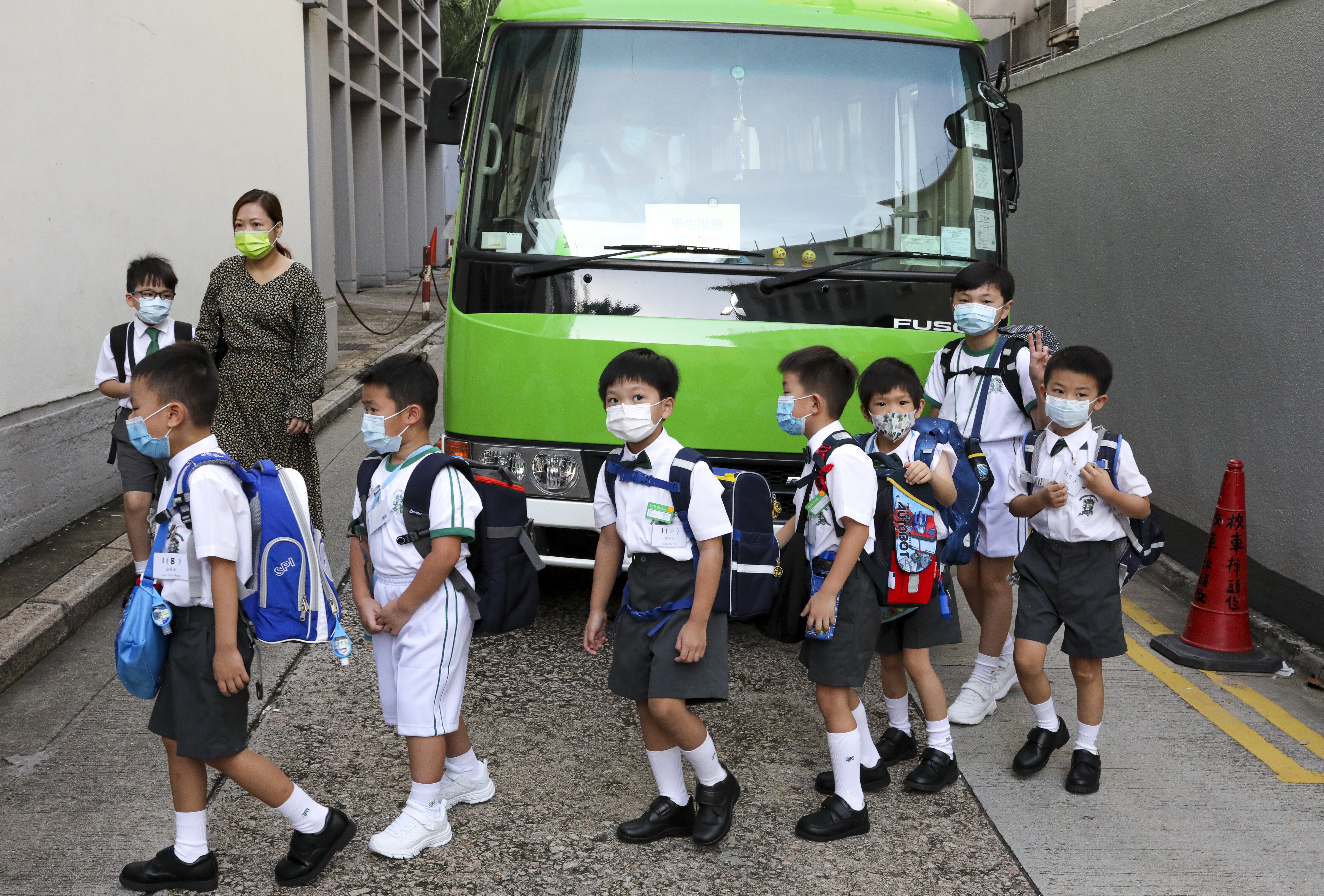Students head to school in Wan Chai in September 2020. The government has announced that all schools will resume on a half-day basis later this month. Photo: SCMP/ Nora Tam
