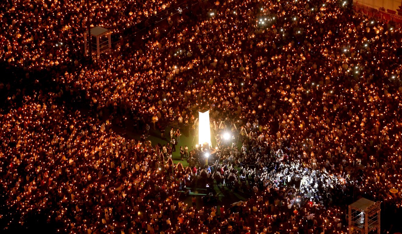 People raise their candles during the June 4 vigil at Victoria Park in 2019. Photo: Dickson Lee