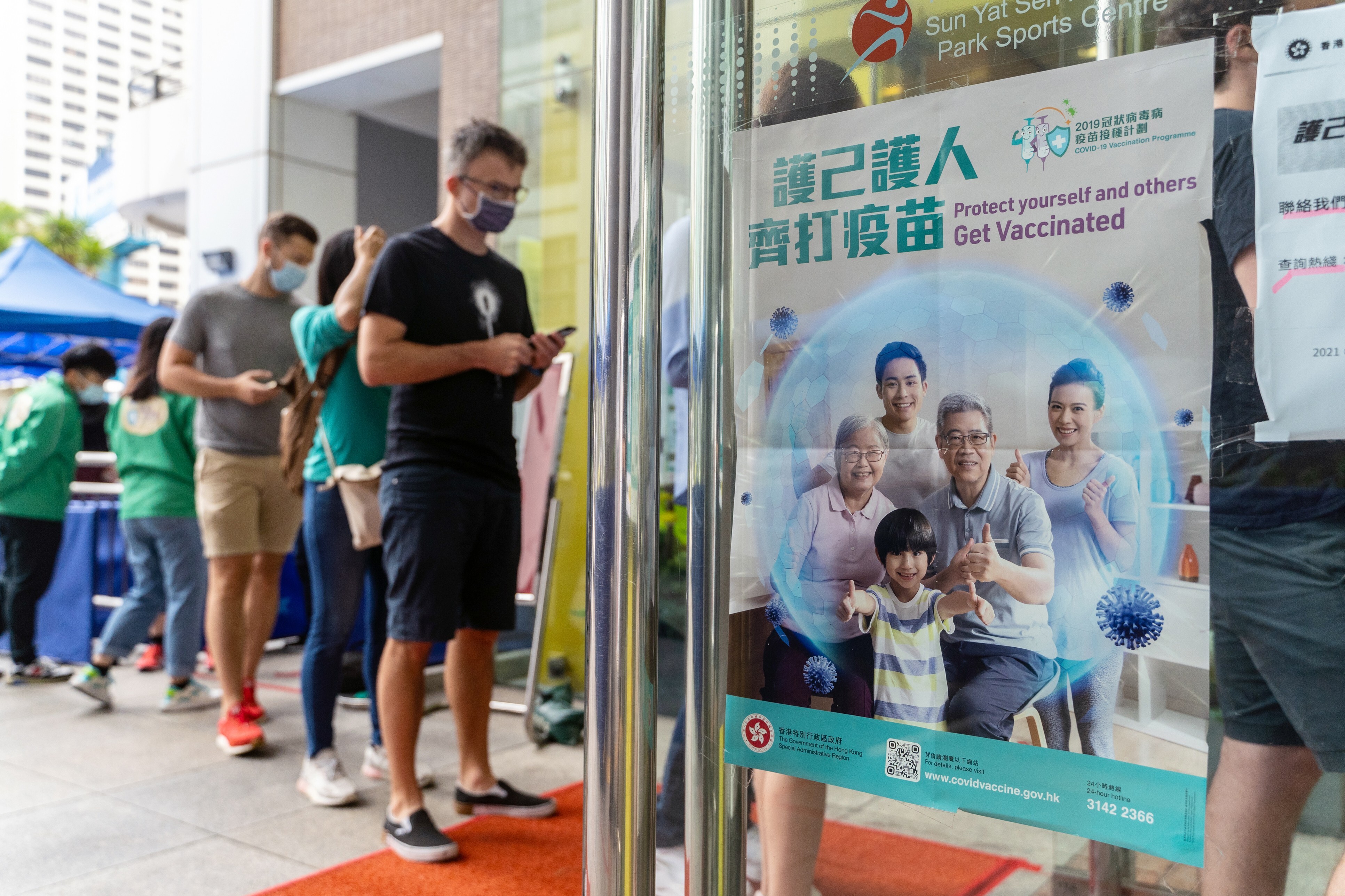 A poster advertising the vaccination programme outside a community vaccination centre in Hong Kong on April 26. Photo: Bloomberg