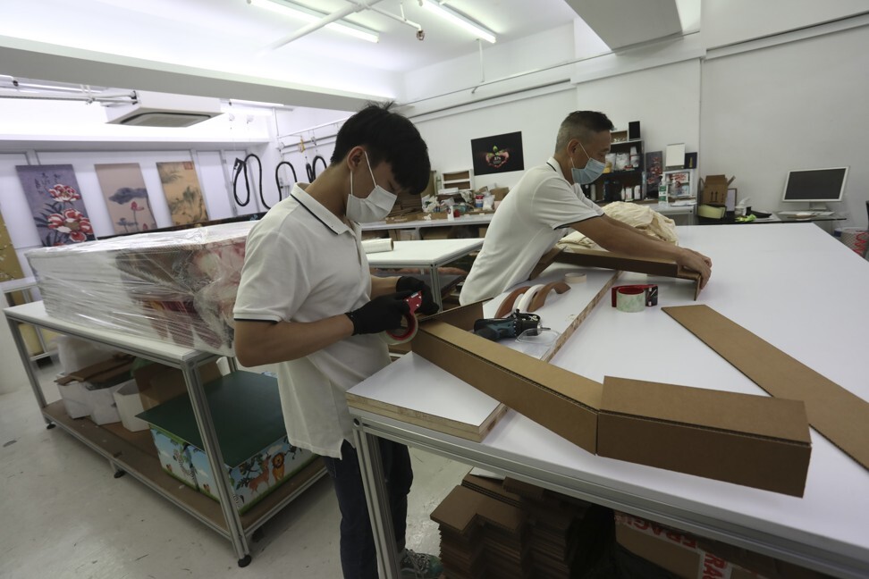 A cardboard coffin is put together by LifeArt workers. Photo: Jonathan Wong