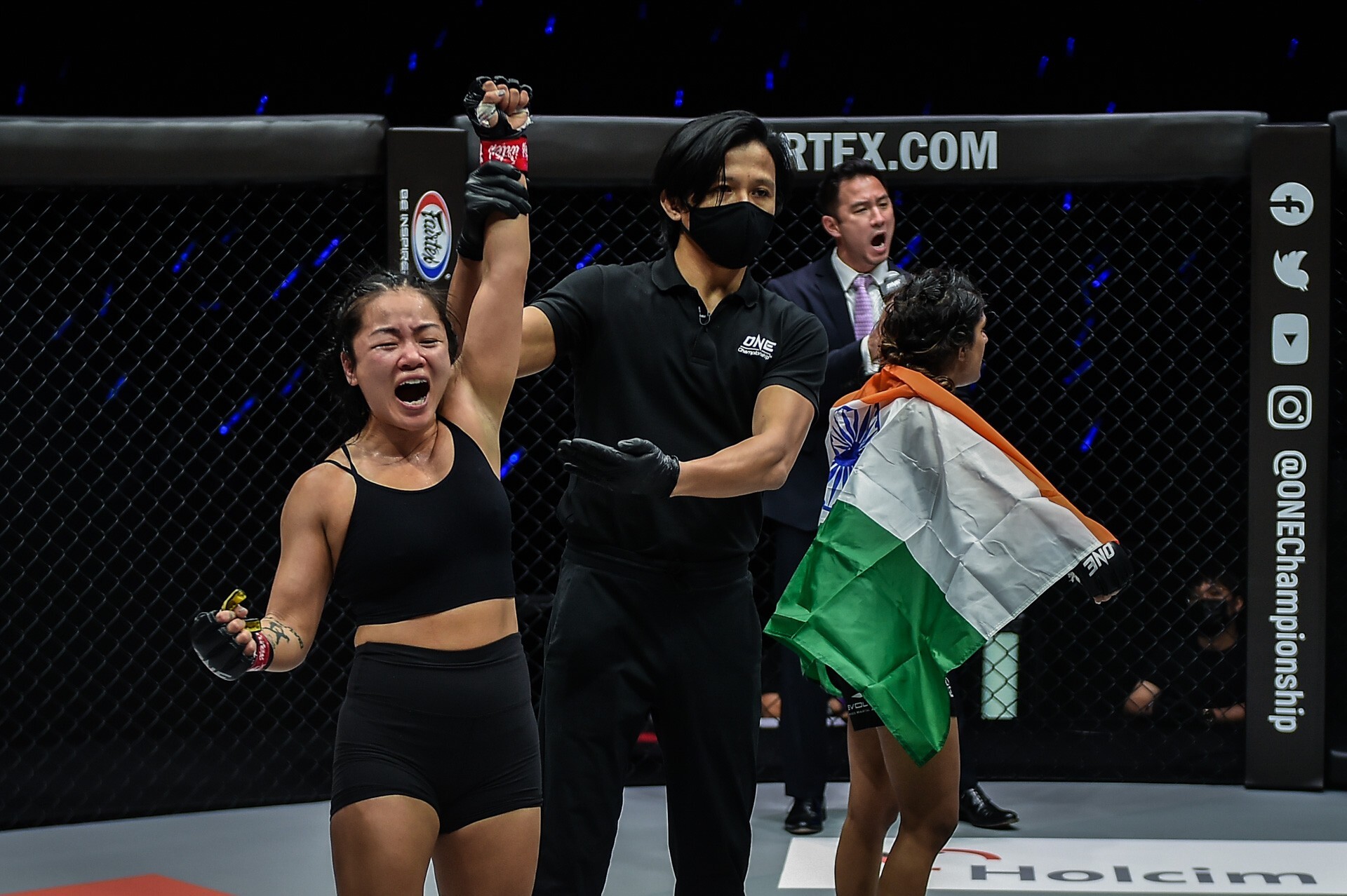 Bi Nguyen'’s arm is raised as Ritu Phogat turns away in shock. Photos: ONE Championship
