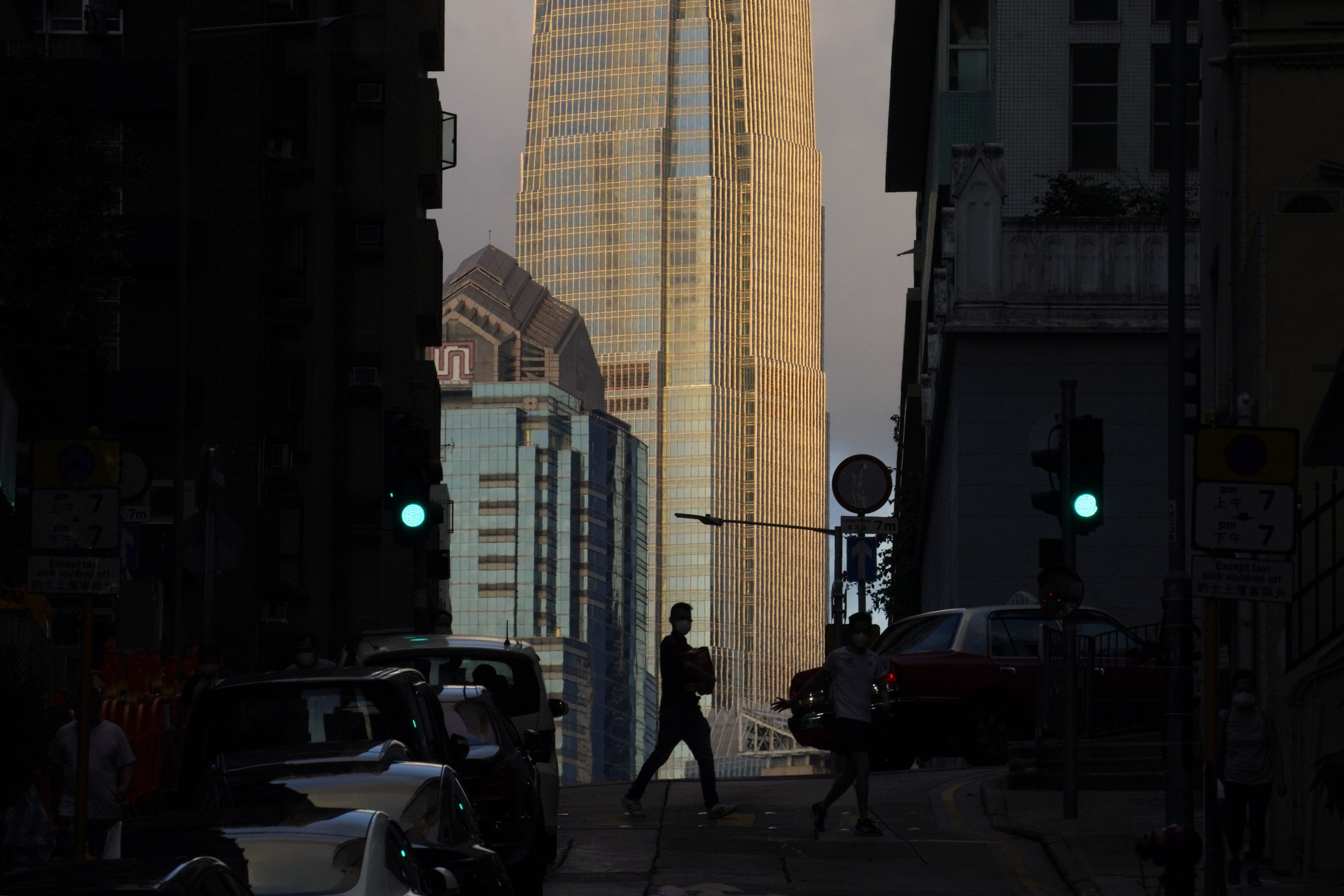 A man walks in front of the IFC tower in Central, Hong Kong, on May 15. Hong Kong is uniquely suited to accommodate the transformation to a new era of finance. Photo: AP