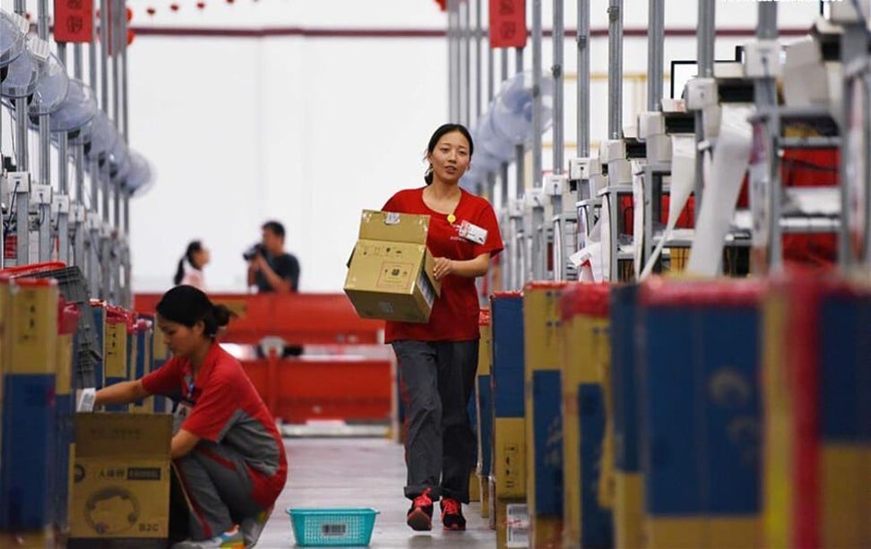 JD.com’s logistics employees are seen at work inside a company warehouse in Gu'an, a country in northern China's Hebei province, as part of preparations for the 618 Midyear Shopping Festival in June 2016. Photo: Xinhua