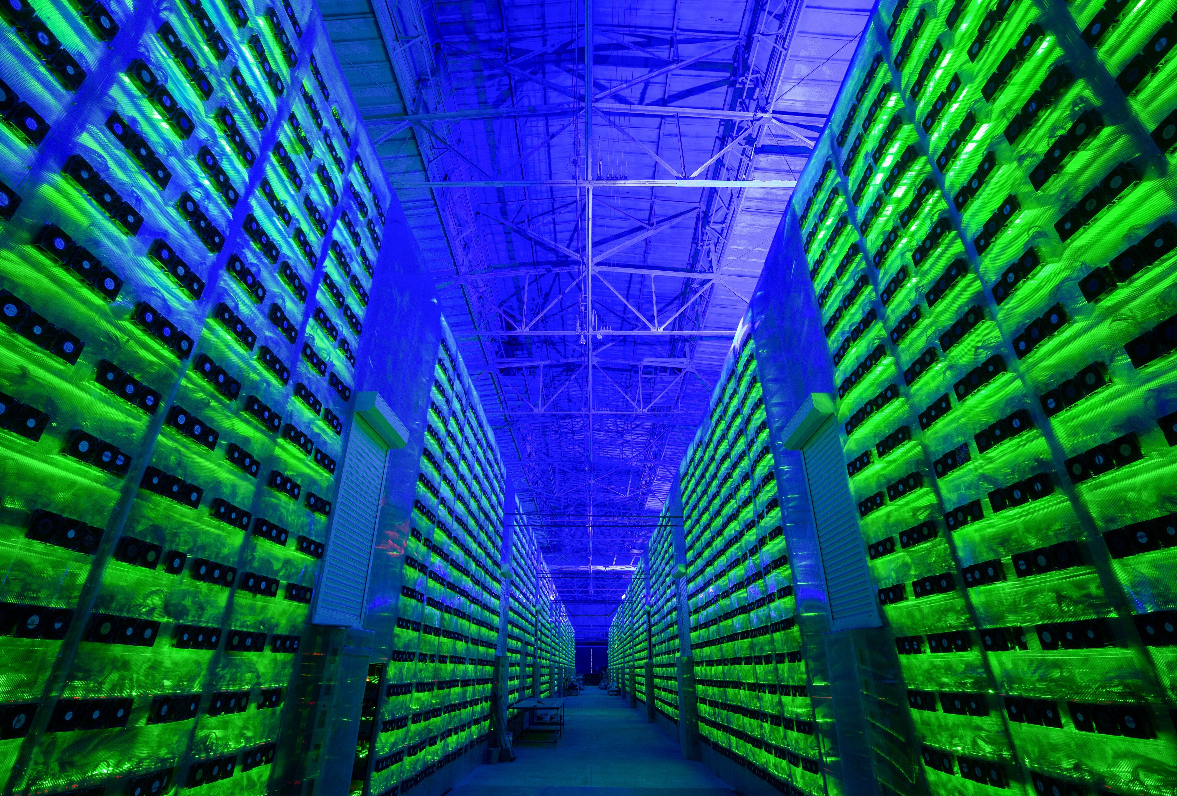 Illuminated mining rigs operate inside racks at the CryptoUniverse cryptocurrency mining farm in Nadvoitsy, Russia, on March 18. Photo: Bloomberg