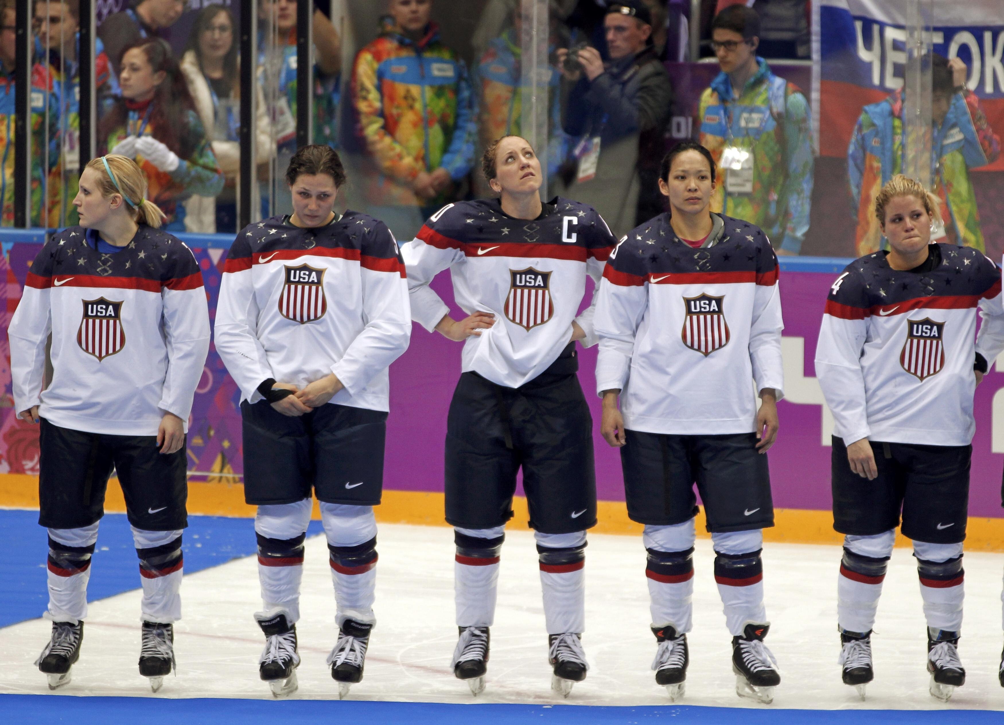 Ice hockey player Julie Chu (second right) with United States team members after missing out on a gold medal against Canada at the Sochi Games in 2014. Photo: Reuters