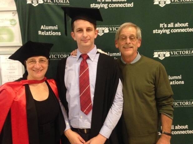 Kelly Savage, centre, pictured with his parents in 2015 at his graduation ceremony. Photo: Hnadout