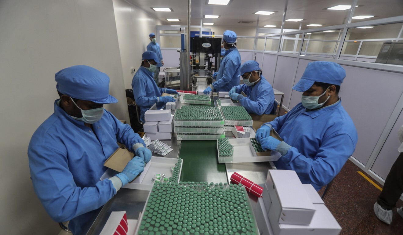 Employees pack boxes containing vials of the Covishield vaccine at the Serum Institute of India. Photo: AP