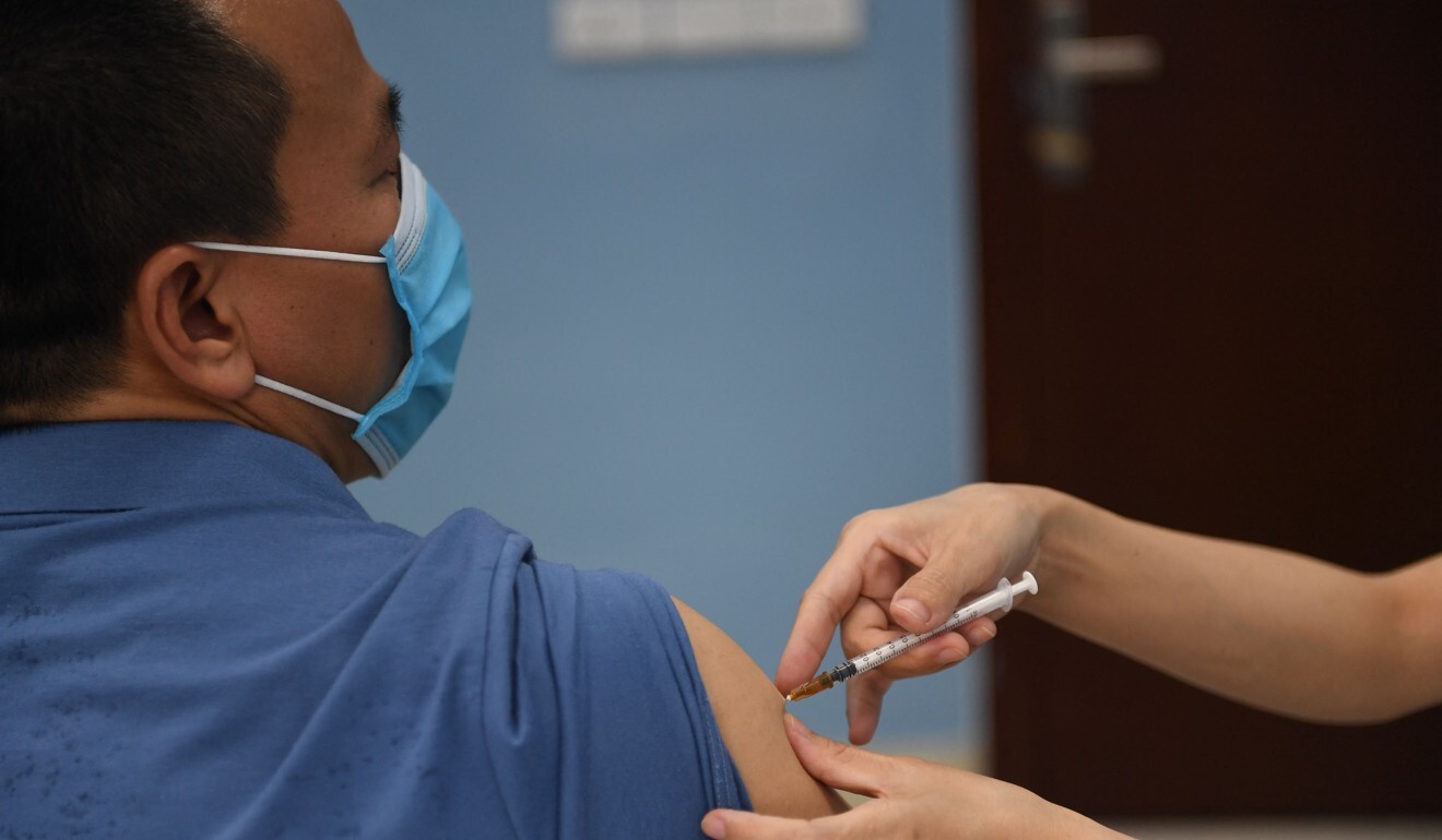 A health worker administers a dose of the AstraZeneca vaccine for the Covid-19 coronavirus at the Bach Mai Hospital in Hanoi. Photo: AFP
