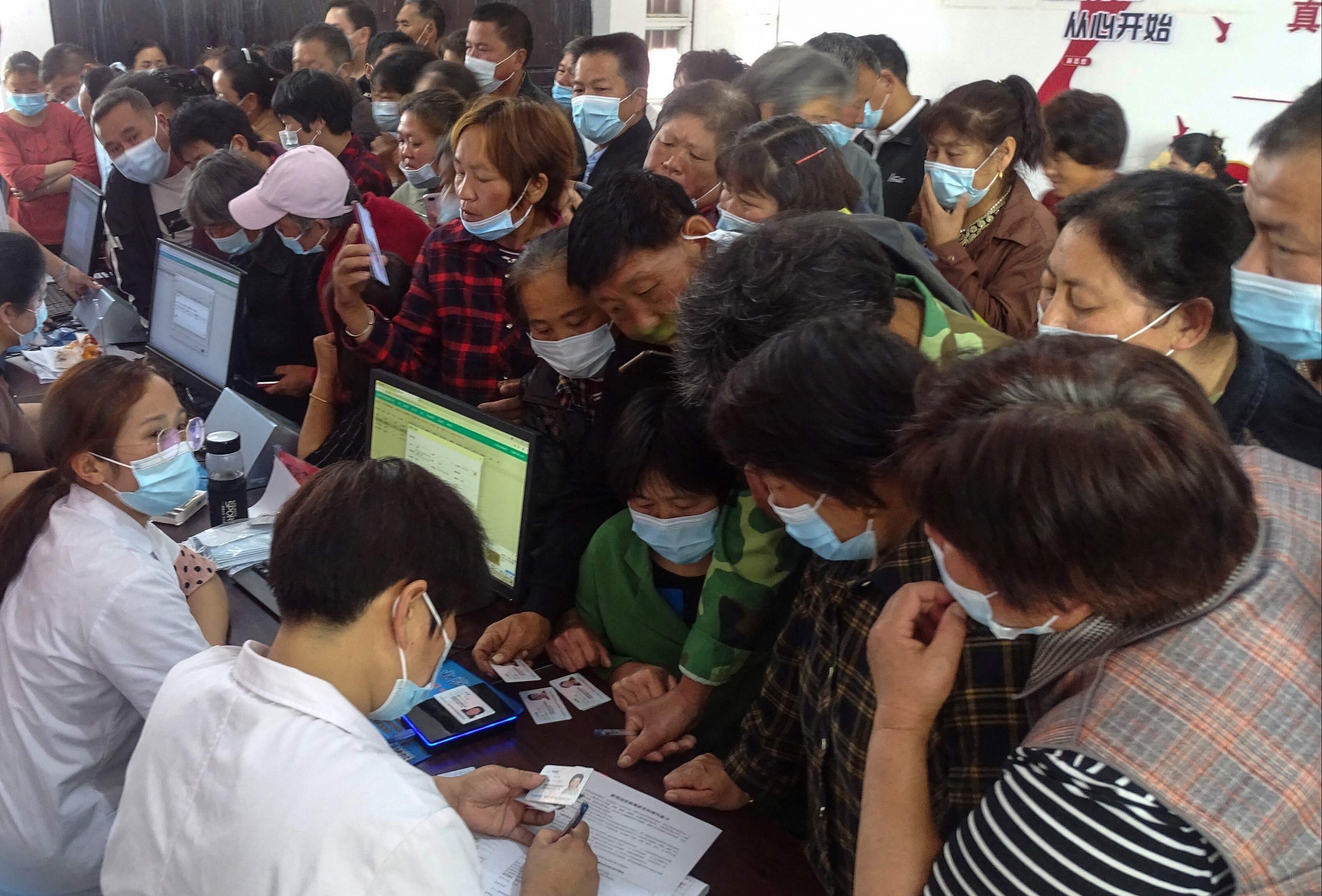 People register information as they prepare to receive the Anhui Zhifei Longcom Covid-19 coronavirus vaccine in Fuyang in eastern Anhui province on May 13. Photo: AFP