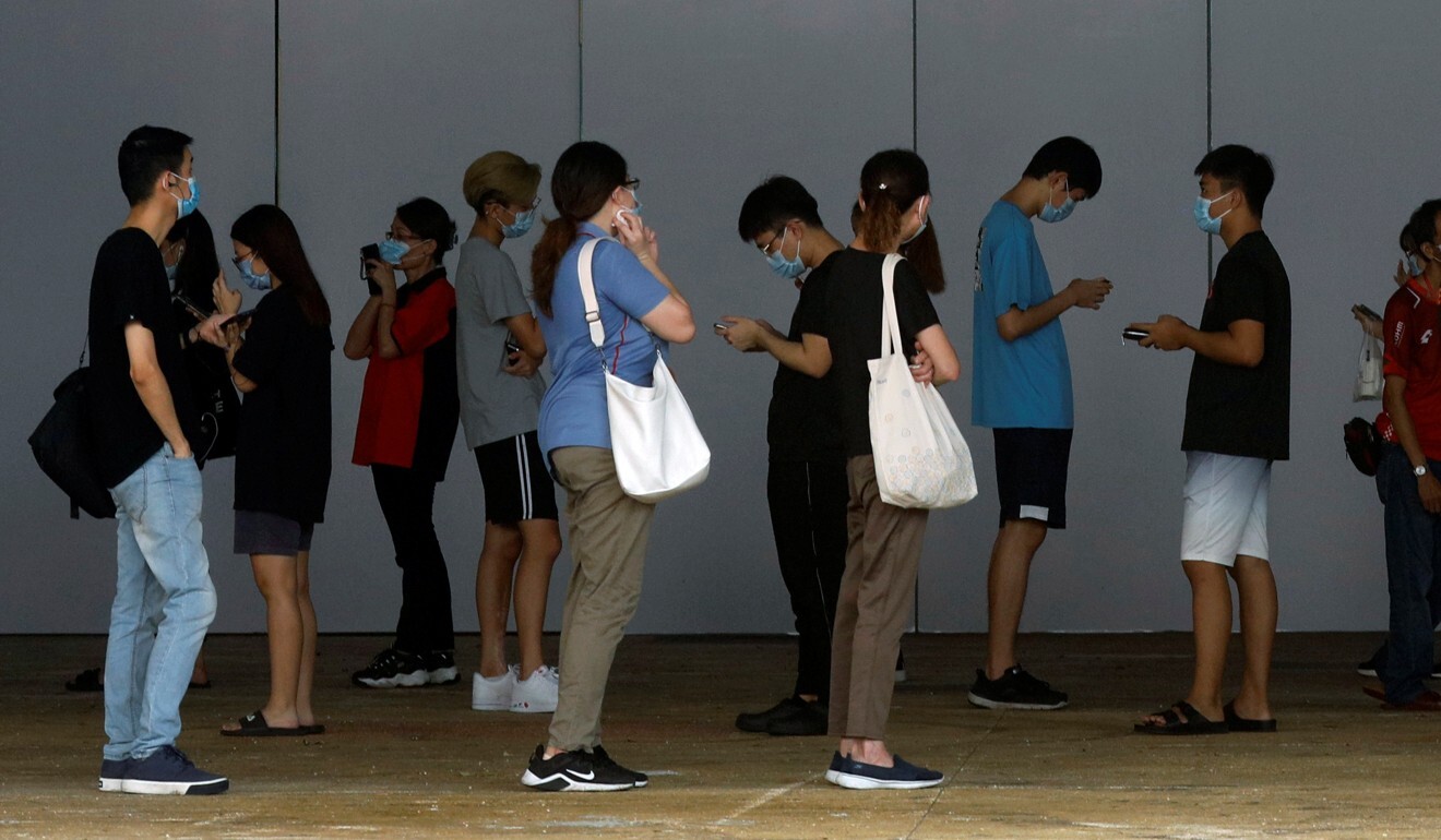 People who had visited a mall which became a coronavirus cluster queue up for swab tests in Singapore. Photo: Edgar Su