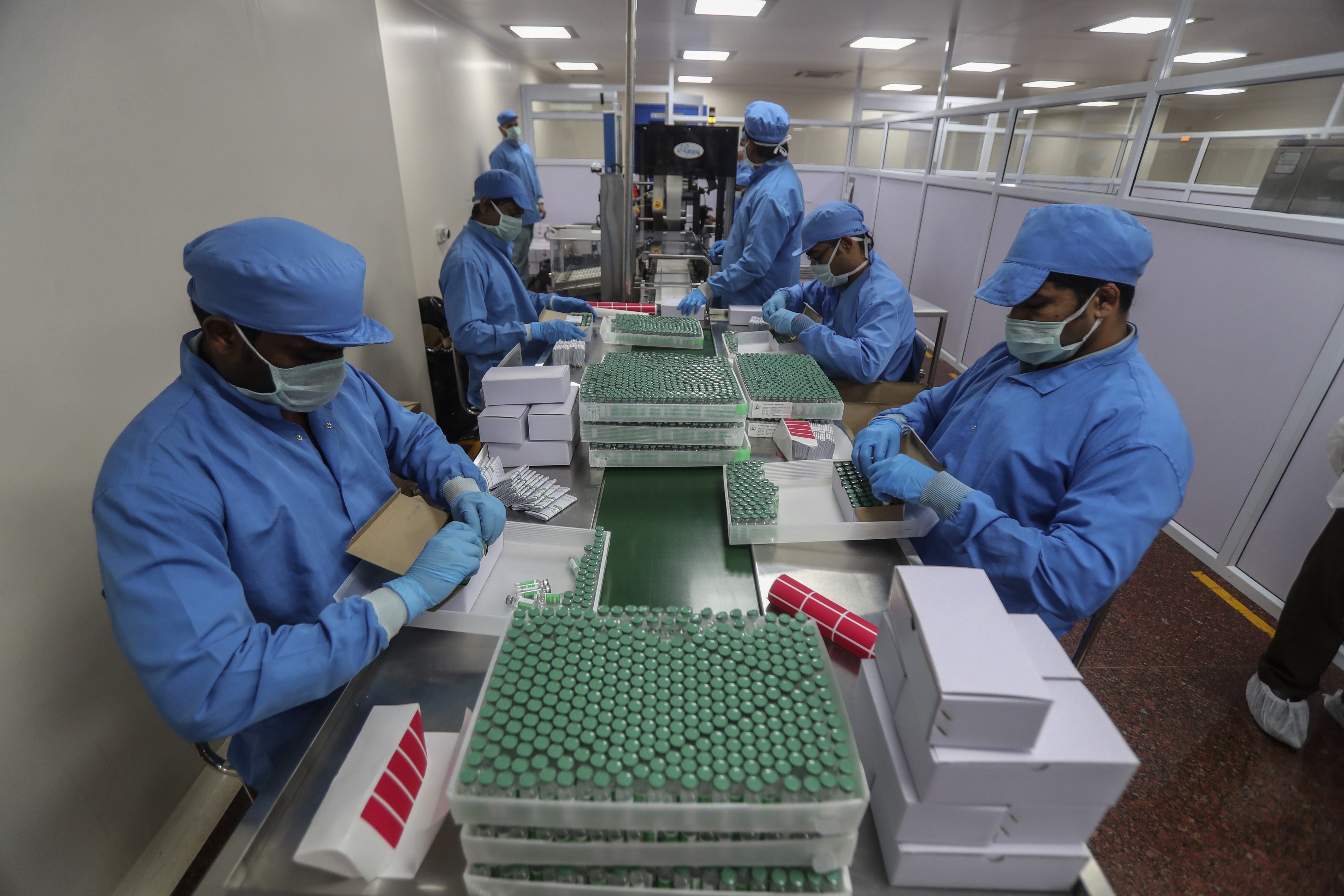 Workers pack boxes containing vials of Covishield, a version of the AstraZeneca vaccine, at the Serum Institute of India in Pune. Photo: AP