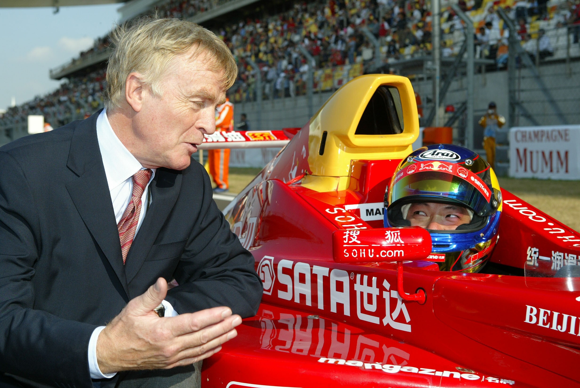 Max Mosley chats to Hong Kong racer Marchy Lee before the Formula BMW Asia race during the inaugural Chinese Grand Prix weekend at Shanghai International Circuit in 2004. Photo: K.Y. Cheng