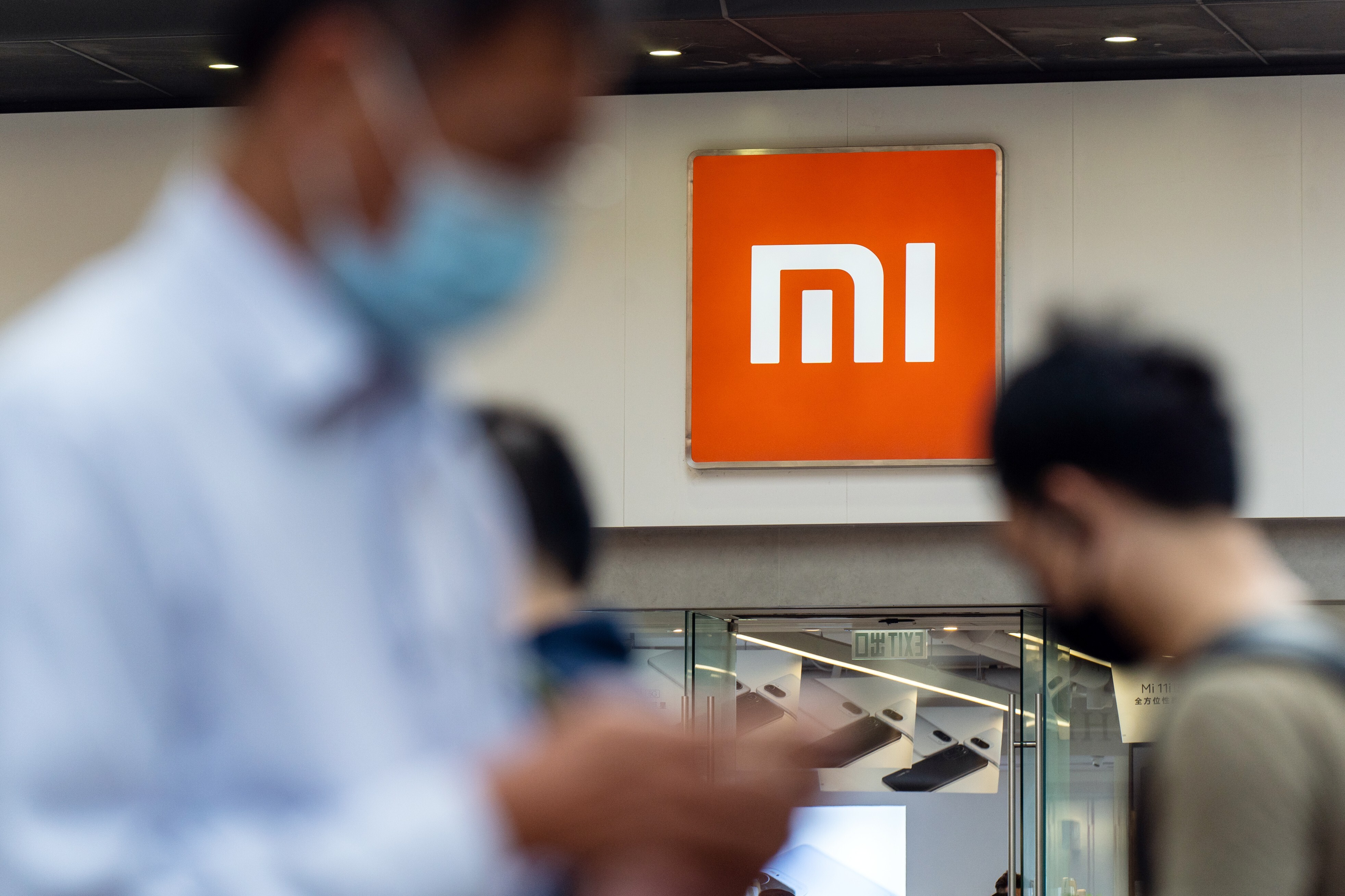 Pedestrians walk past a Xiaomi Corp store in Hong Kong on May 25, 2021. Photo: Bloomberg