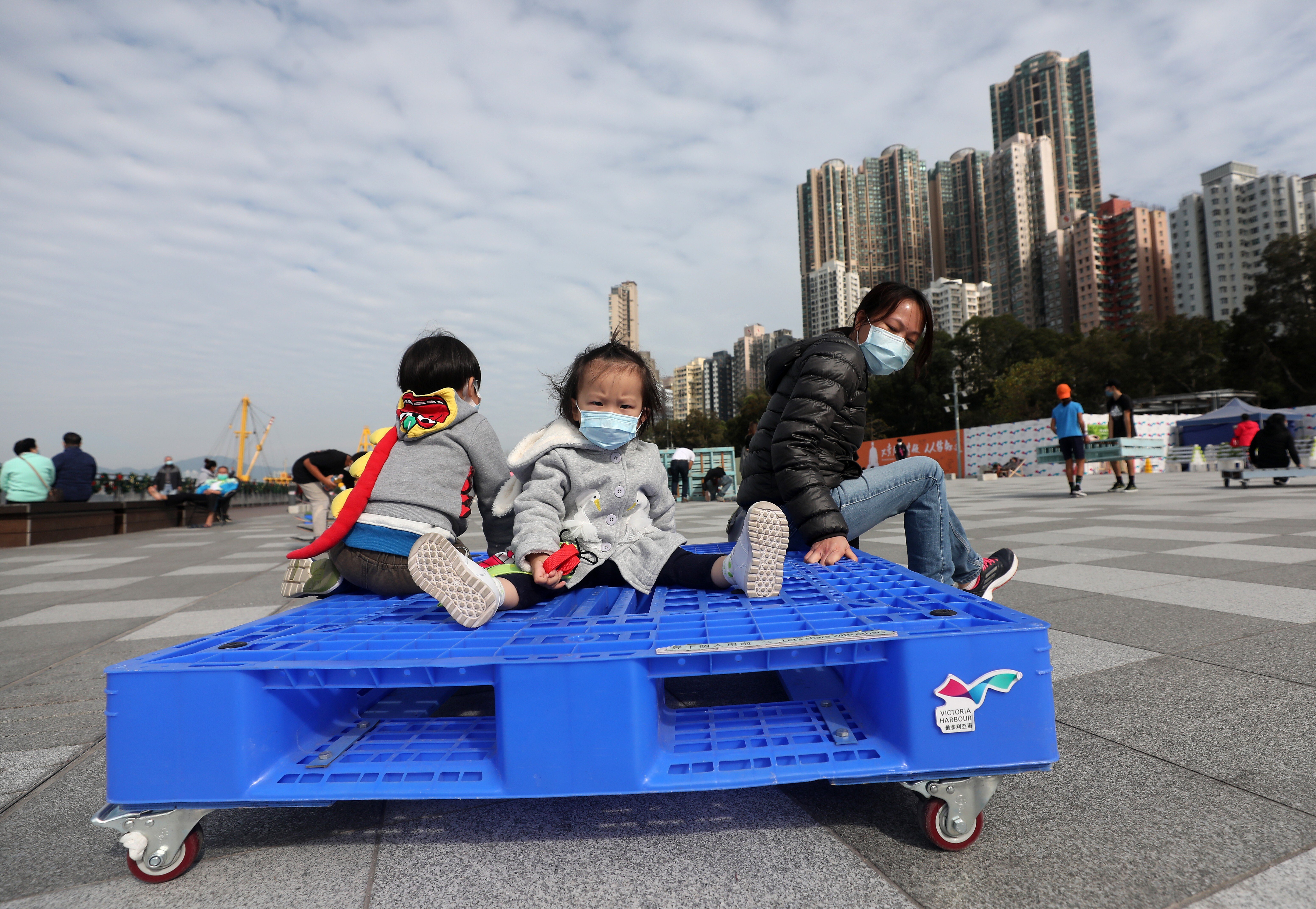 Adults and children enjoy a sunny day at Belcher Bay Promenade in Kennedy Town, Hong Kong. Photo: Xiaomei Chen