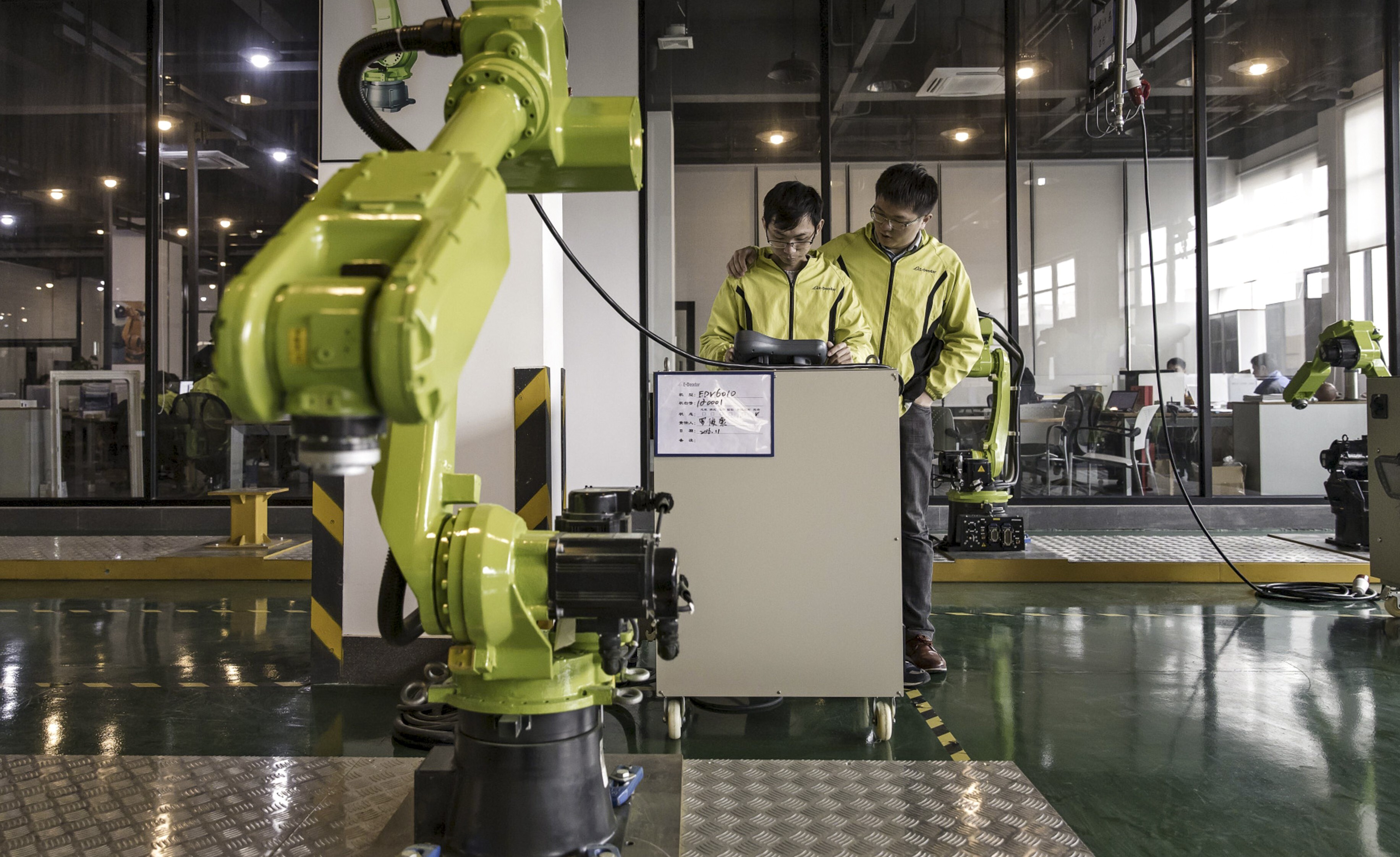 Technicians test robots in a E-Deodar Robot Equipment Co factory in Foshan, a part of the Greater Bay Area, on February 28, 2017. The Greater Bay Area is where the future of finance and technology is being written and start-ups in the Asean region can learn from its experiences. Photo: Bloomberg
