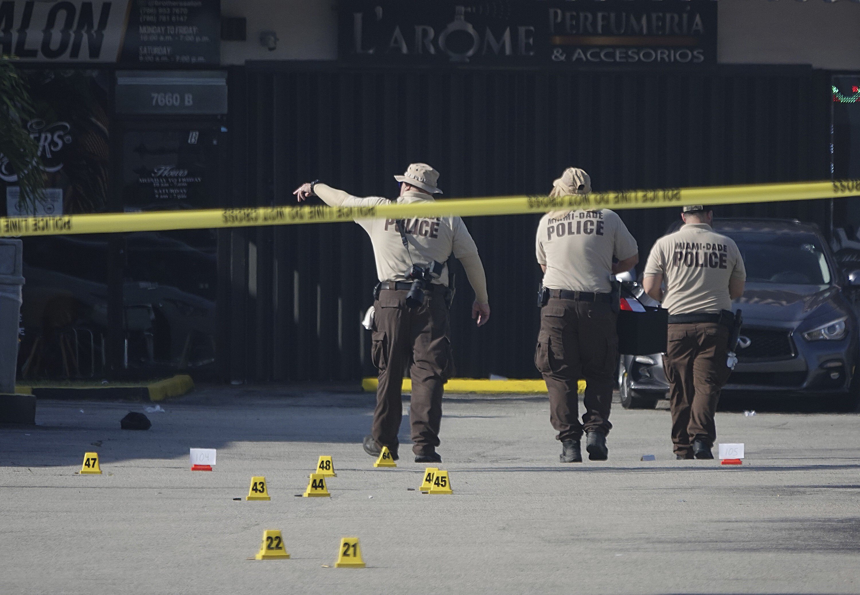 Miami-Dade police work the scene of a shooting outside a banquet hall. Photo: AP
