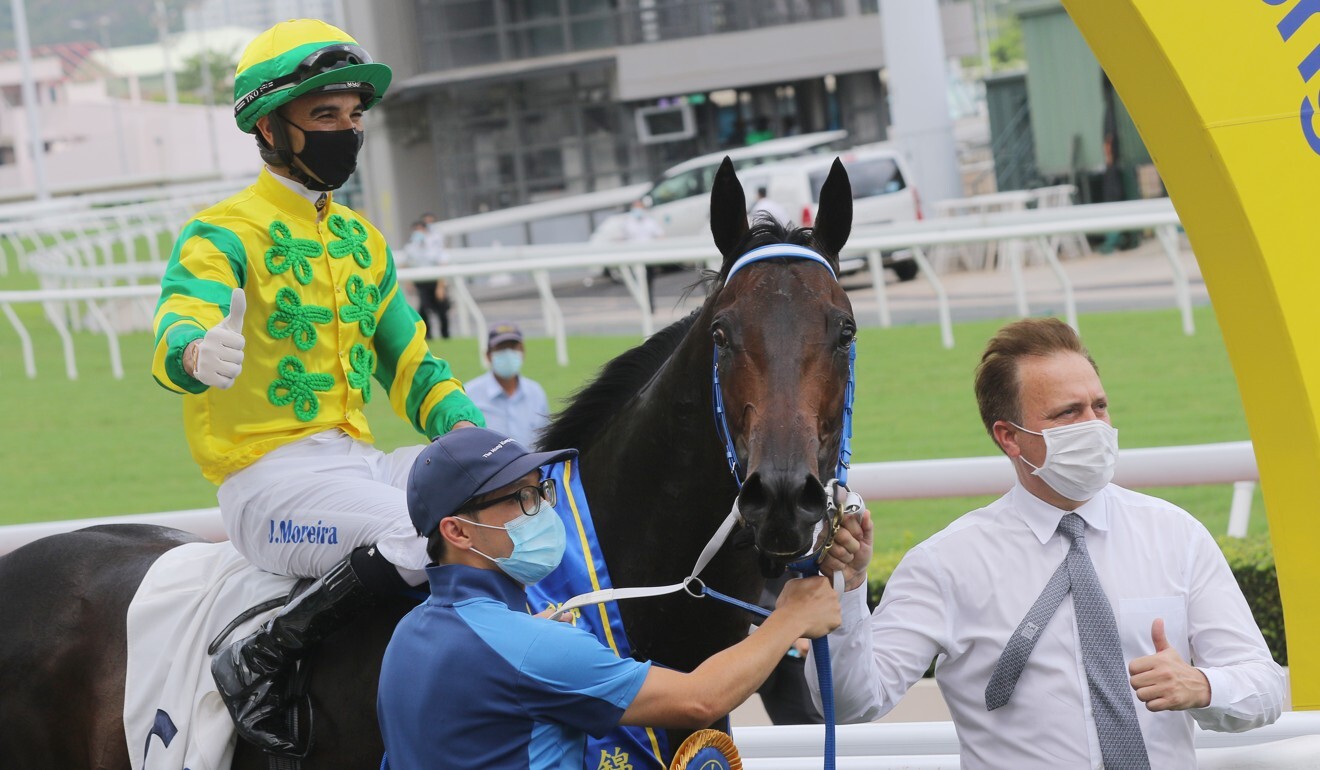 Jockey Joao Moreira and trainer Caspar Fownes celebrate Sky Darci’s victory.