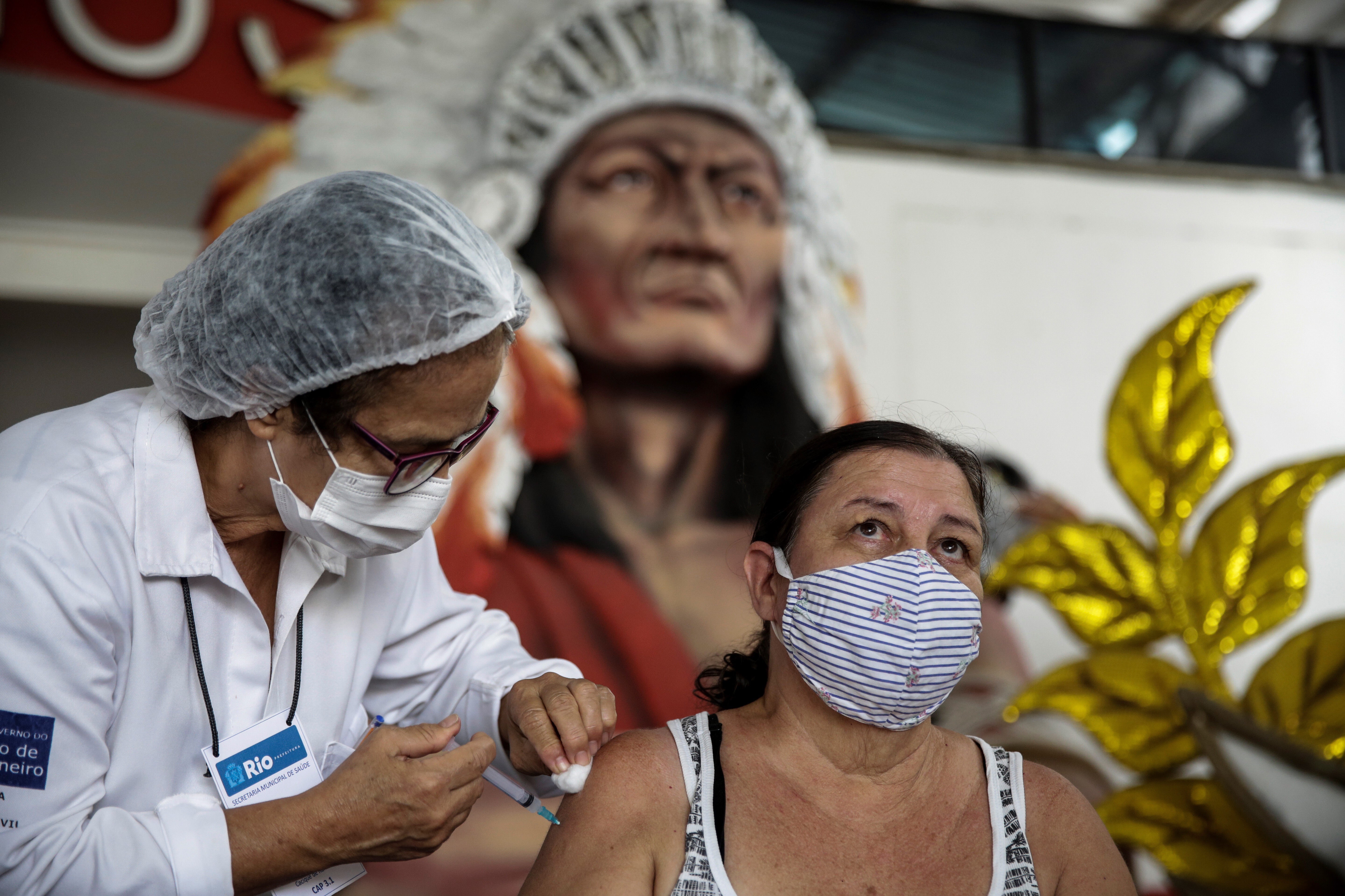 A woman receives a Sinovac shot in Rio de Janeiro, Brazil. The country has purchased 47 doses of Chinese vaccines for every 100 people. Photo: EPA-EFE