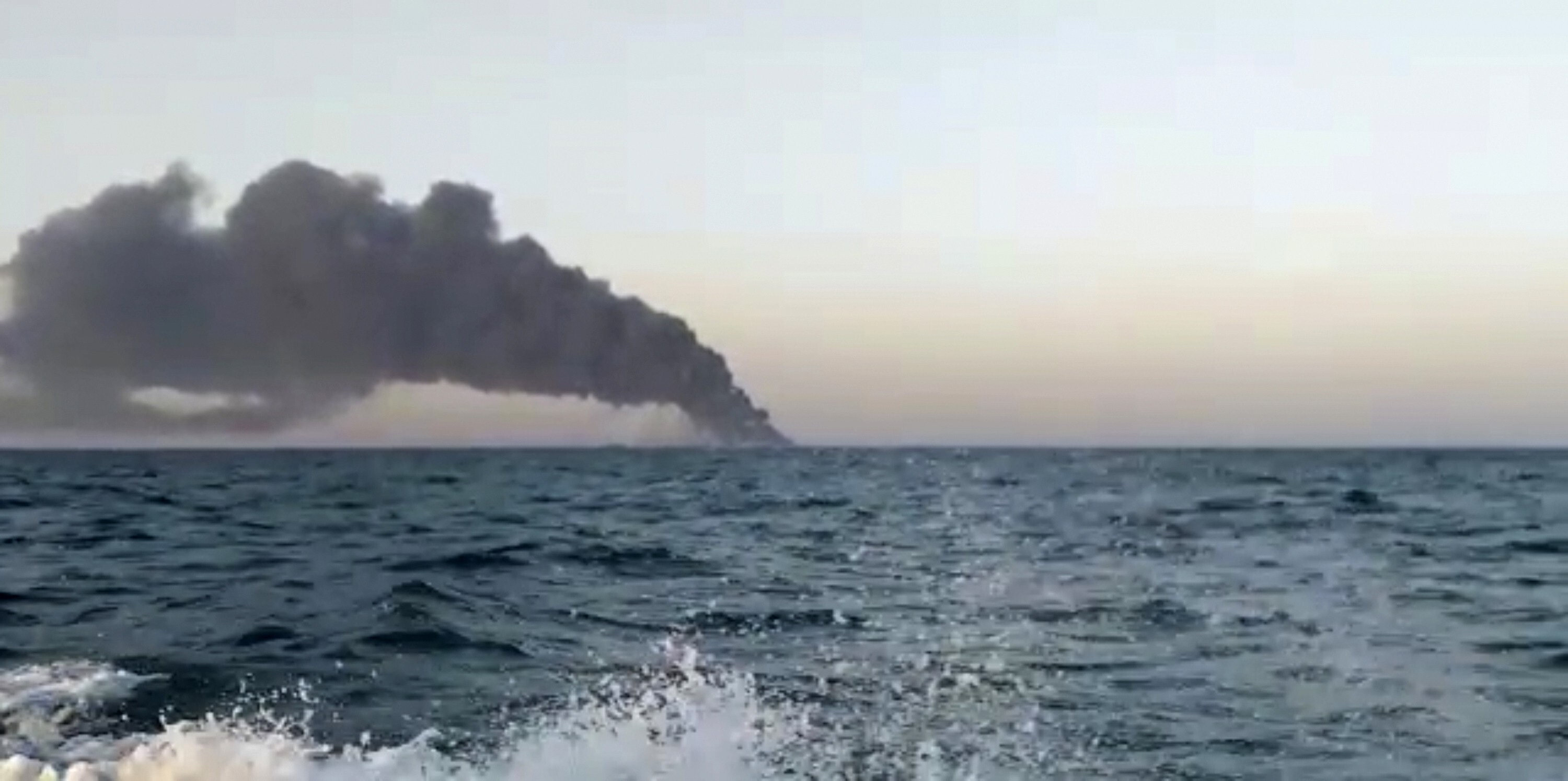 Smoke rises from Iran's navy support ship Kharg in the Gulf of Oman. Photo: AP