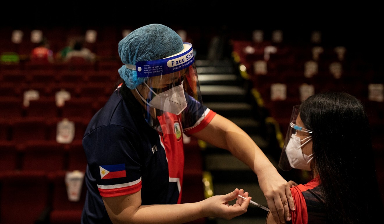 A woman receives a dose of Sinovac Biotech's CoronaVac vaccine in a cinema turned into a vaccination site in San Juan City, Metro Manila, earlier this month. Photo: Reuters