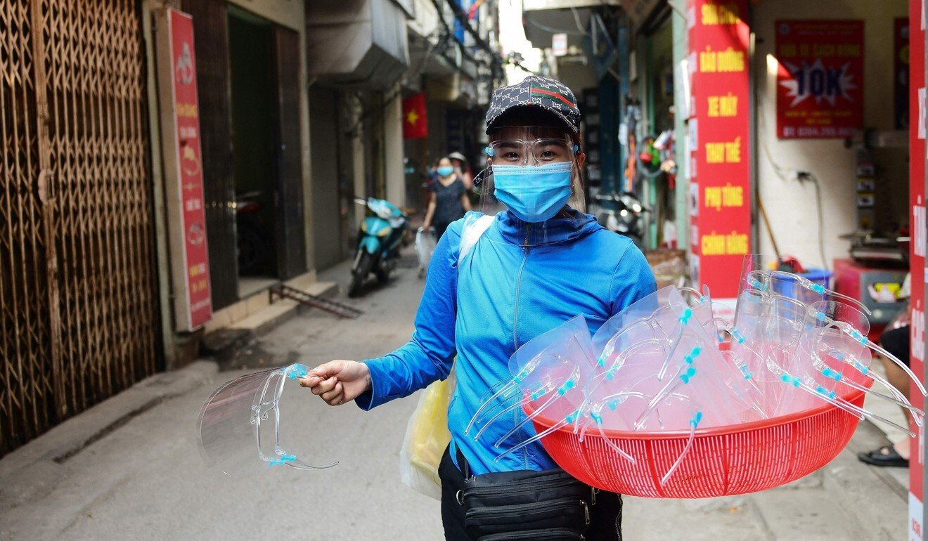A man sells plastic face shields amid the latest coronavirus outbreak in Hanoi. Photo: AFP