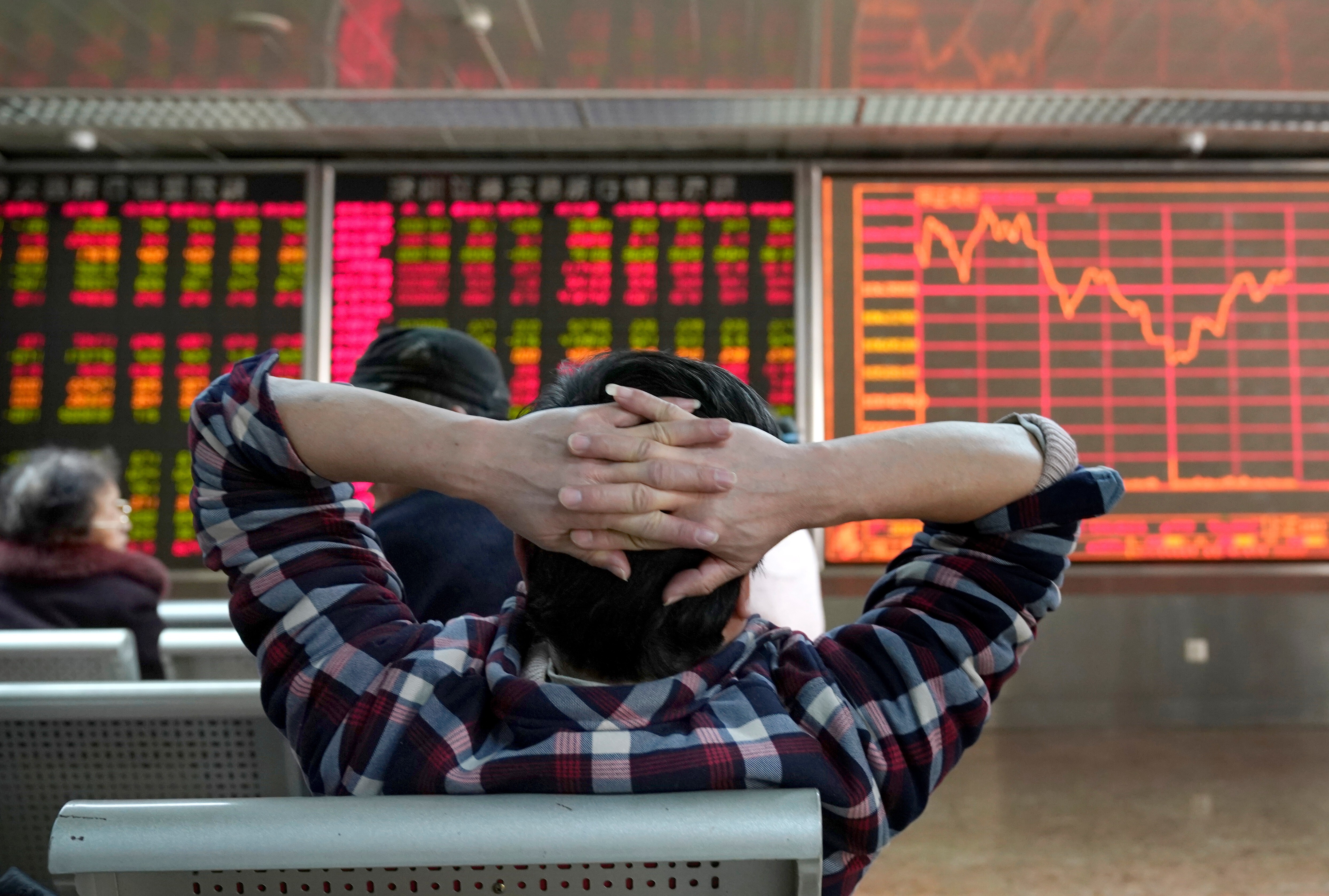 An investor looks at a stock quotation board at a brokerage office in Beijing, China January 3, 2020. Photo: Reuters