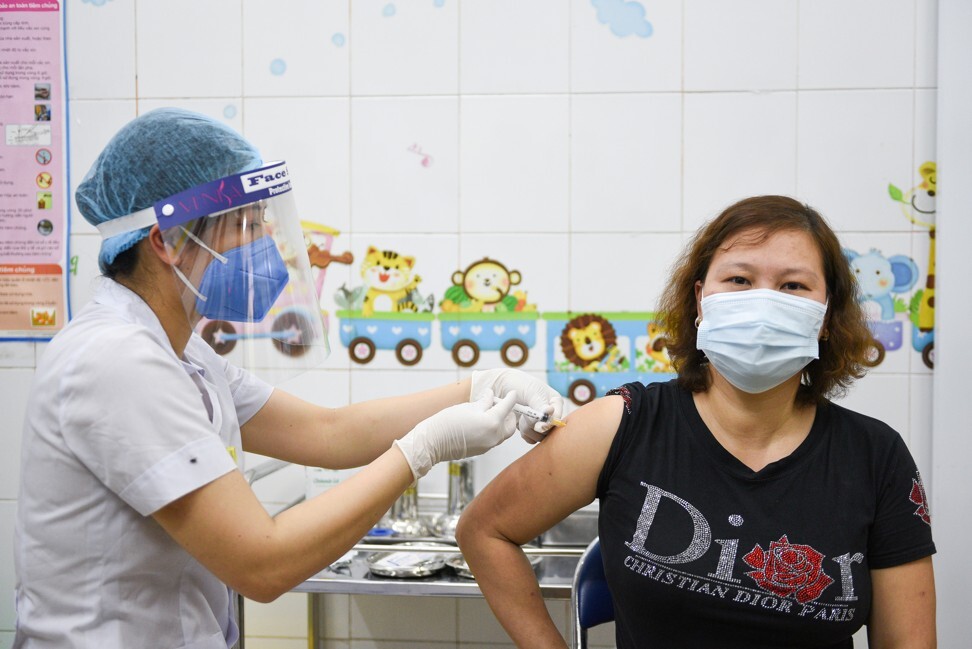 A woman receives an AstraZeneca vaccine shot in Hai Duong province. Photo: Reuters