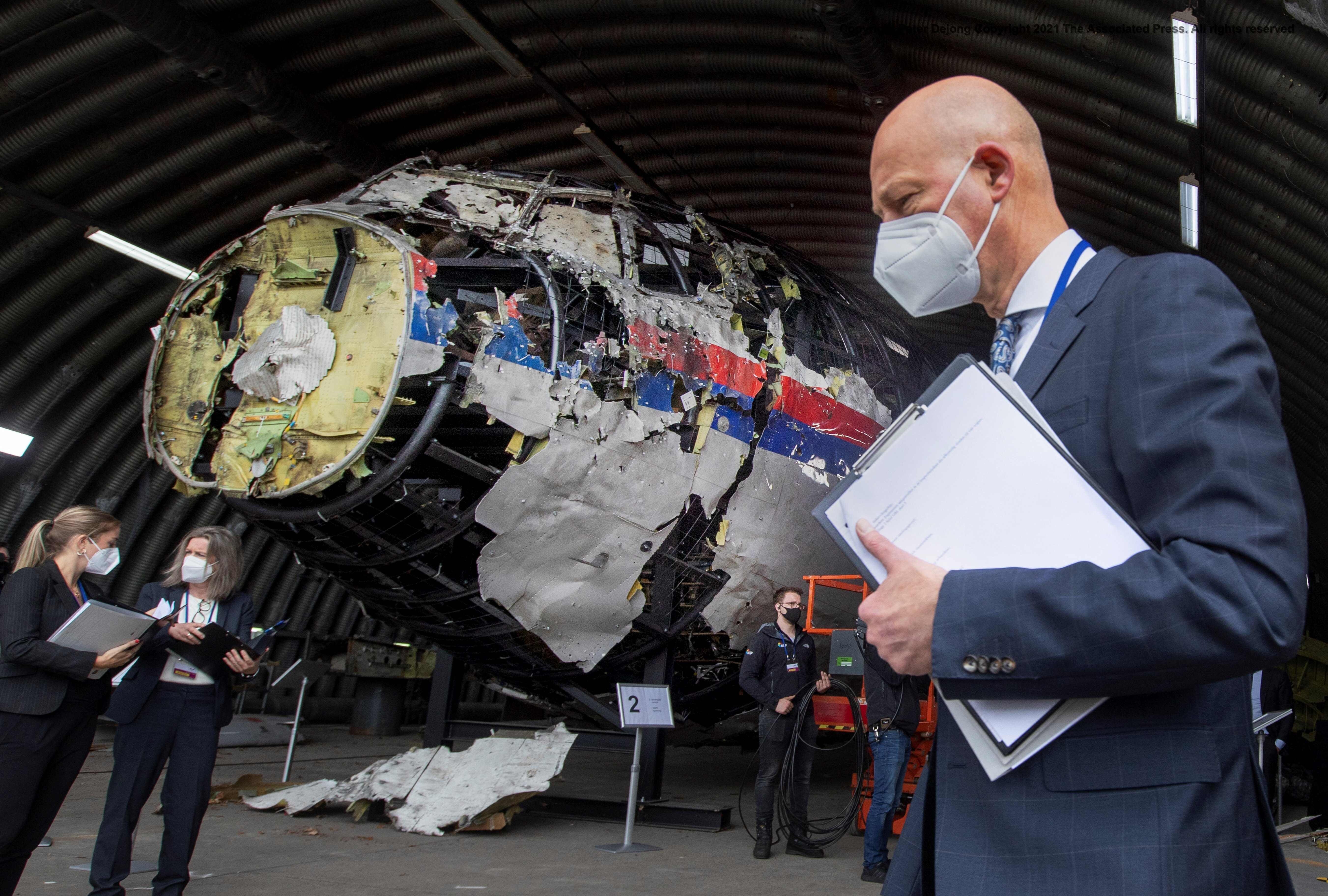 Presiding judge Hendrik Steenhuis and other judges and lawyers view the reconstructed wreckage of Malaysia Airlines flight MH17, at the Gilze-Rijen military airbase, in May. Photo: AFP