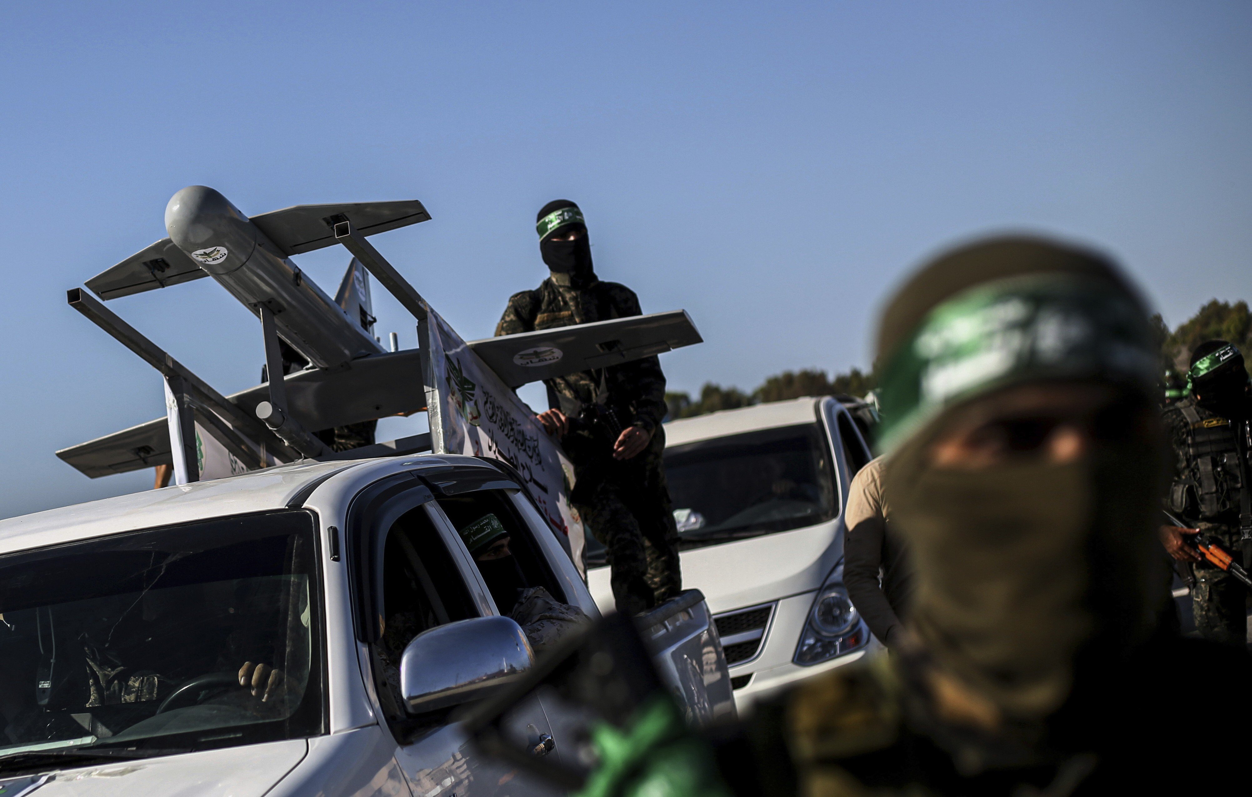 Palestinian Hamas masked gunmen parade with a drone on the back of a truck through the streets of a town in the southern Gaza Strip last month. Photo: AP