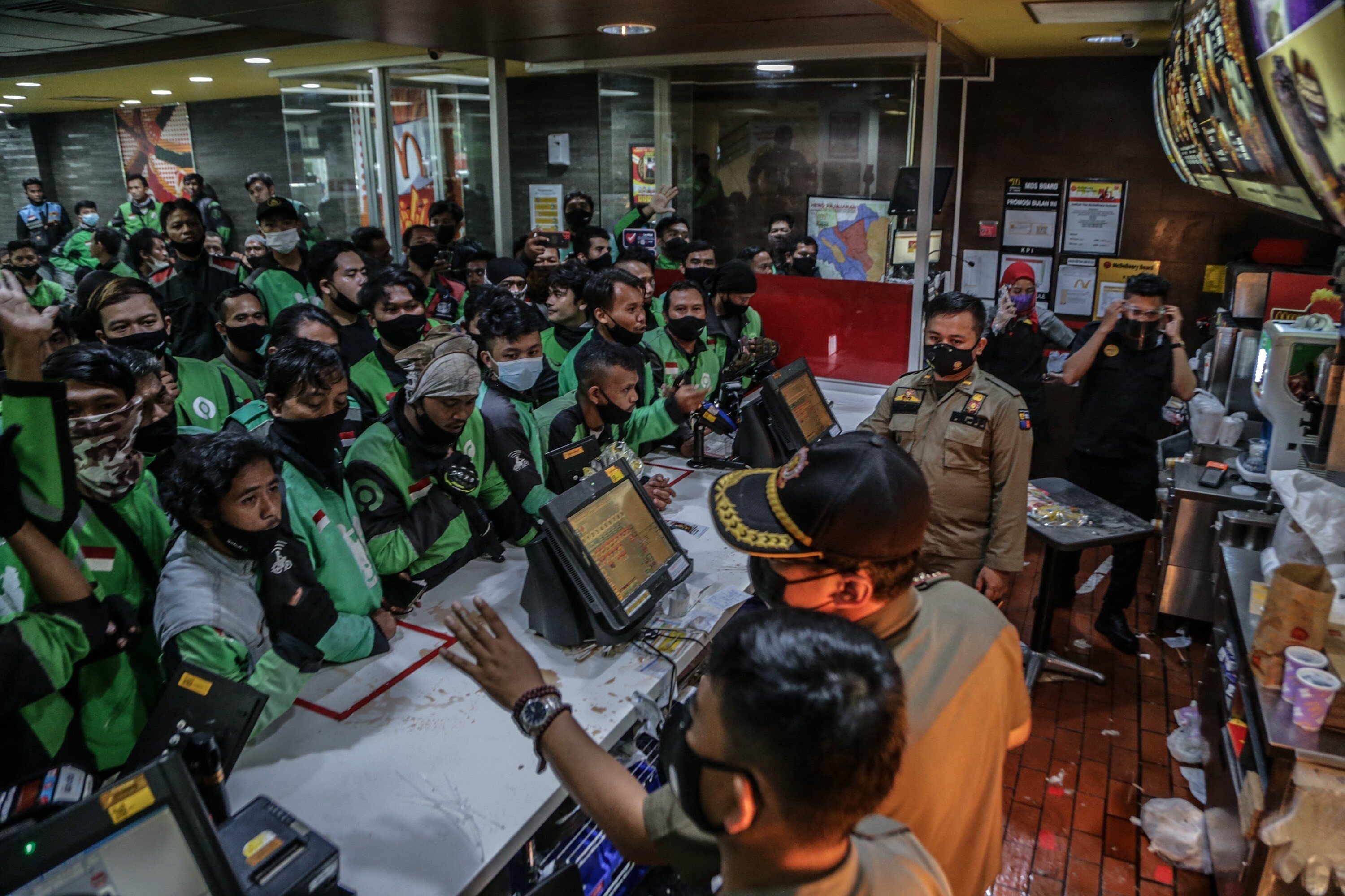 Indonesian food delivery riders queue up at a McDonald’s outlet in Bogor to buy the BTS meal deal for customers. Photo: AFP