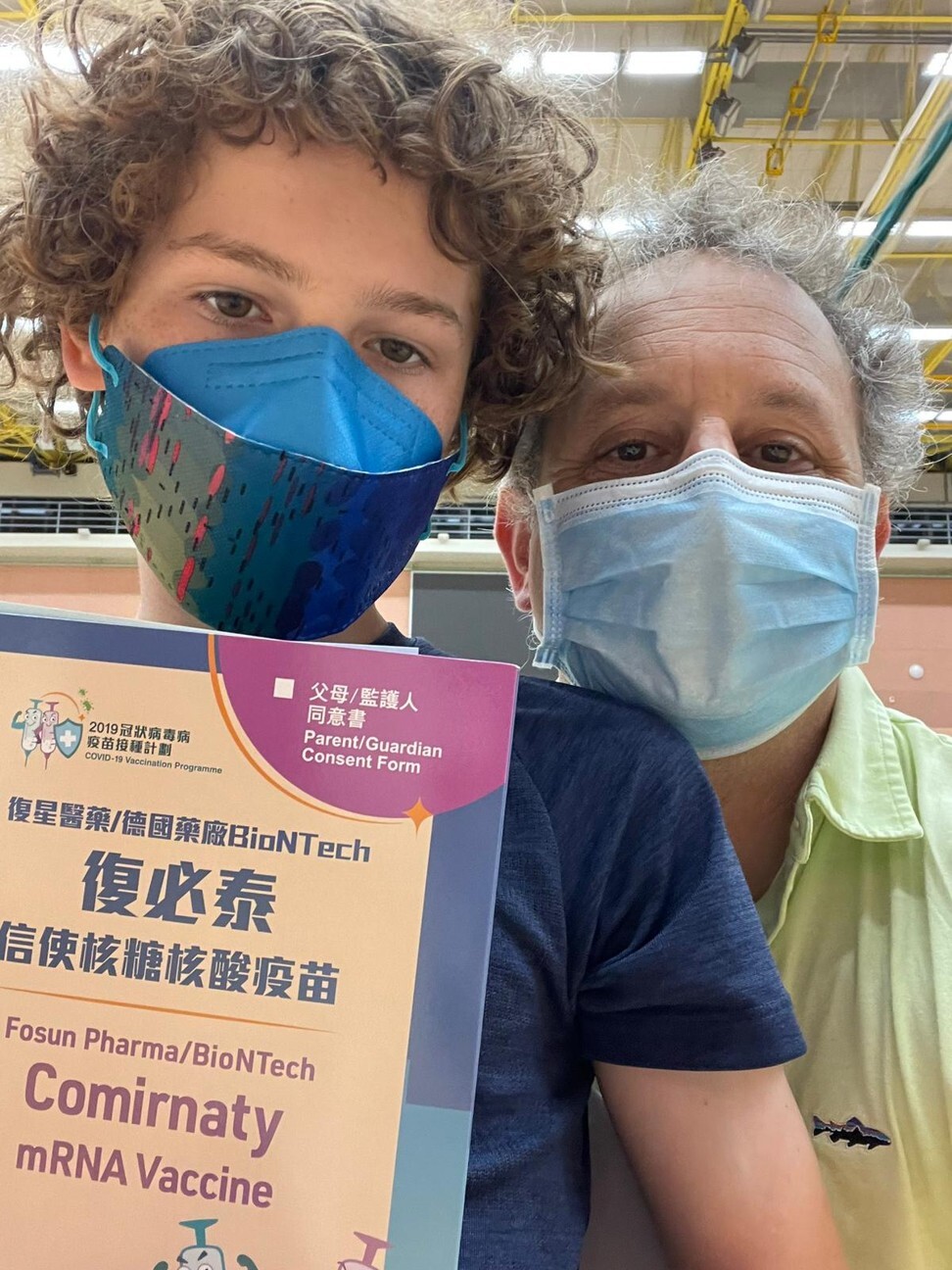 Jed Kaplan and his 12-year-old son outside Sun Yat Sen Memorial Park Sports Centre after getting the Covid-19 vaccine. Photo: Handout