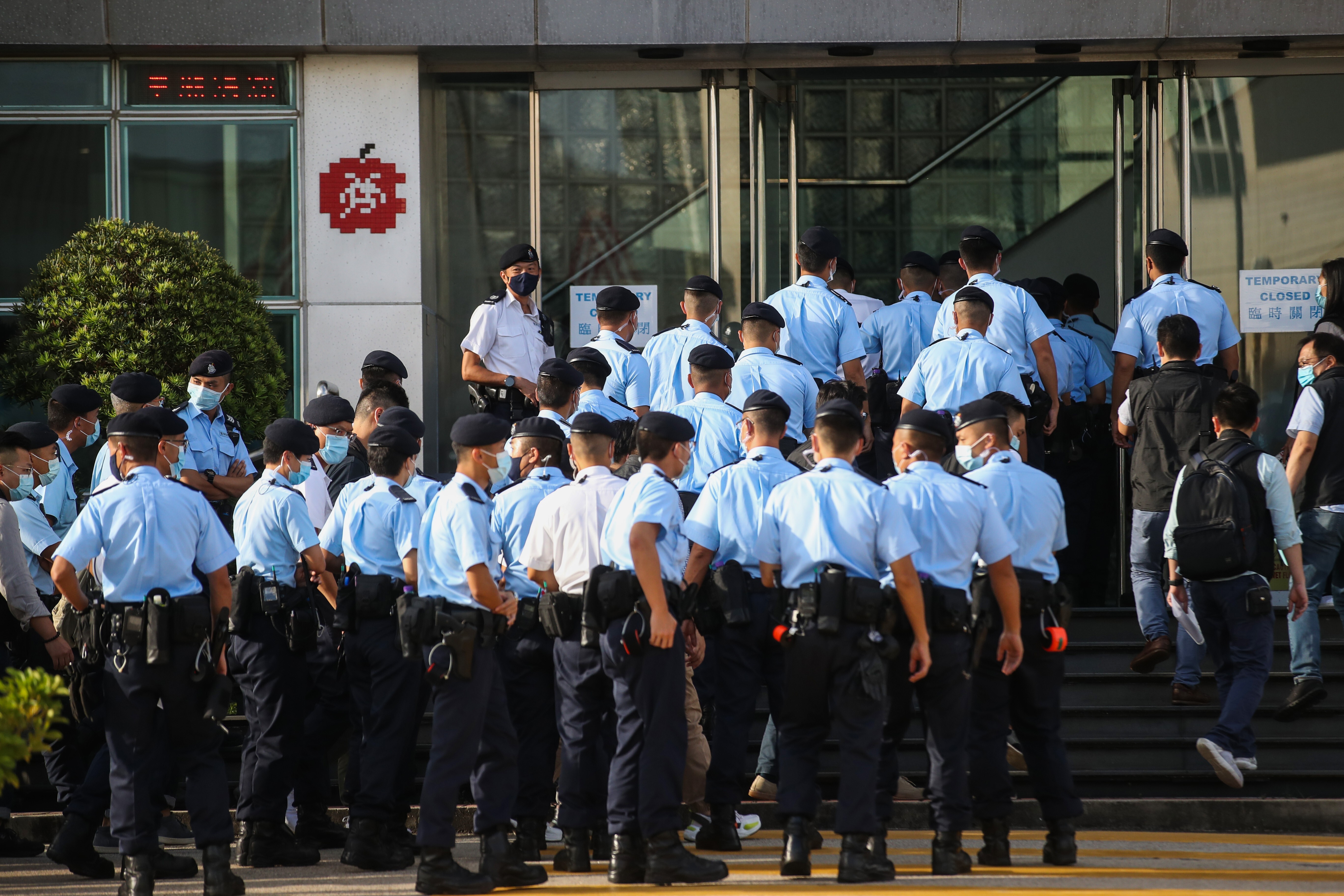 Police officers set up cordon line outside Next Digital Limited building in Tseung Kwan O. (Photo: SCMP / Winson Wong)