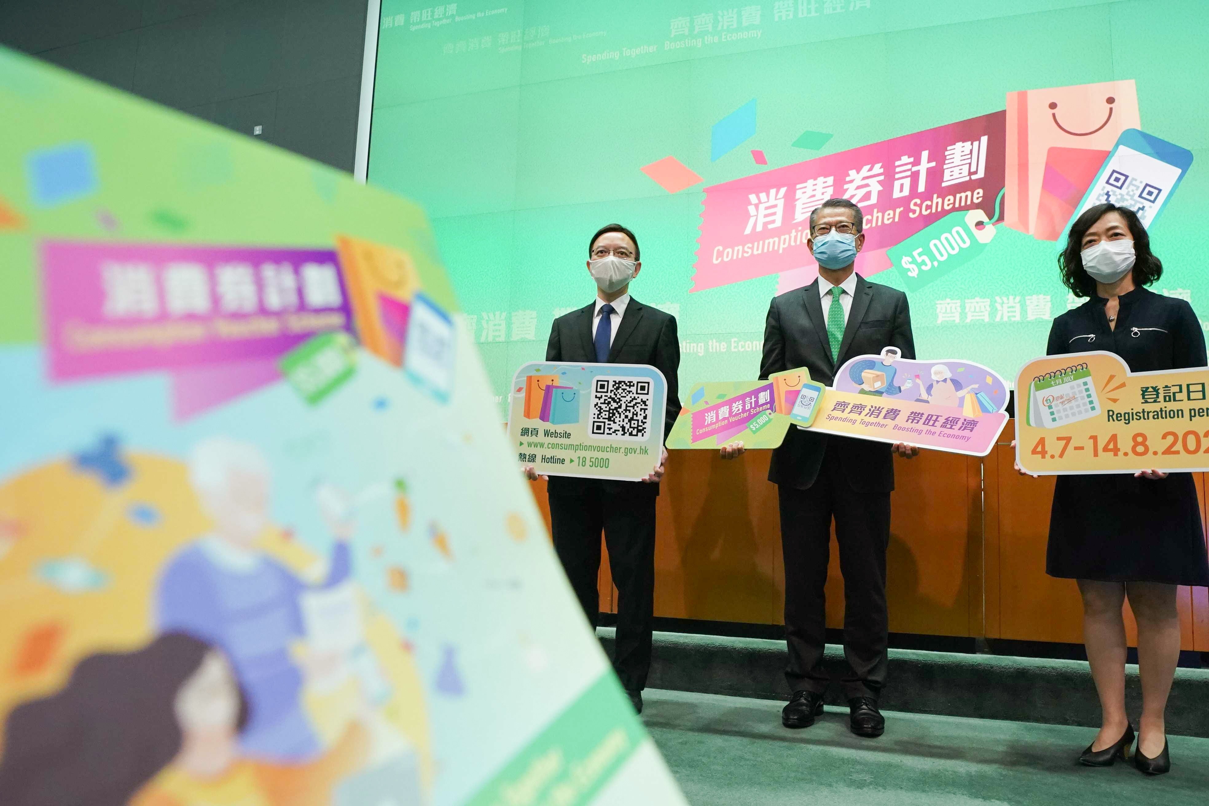 Hong Kong Financial Secretary, Paul Chan (midde), and other government officials held a press conference Friday to announce details of the city’s cash voucher scheme. (Photo: SCMP / Felix Wong)