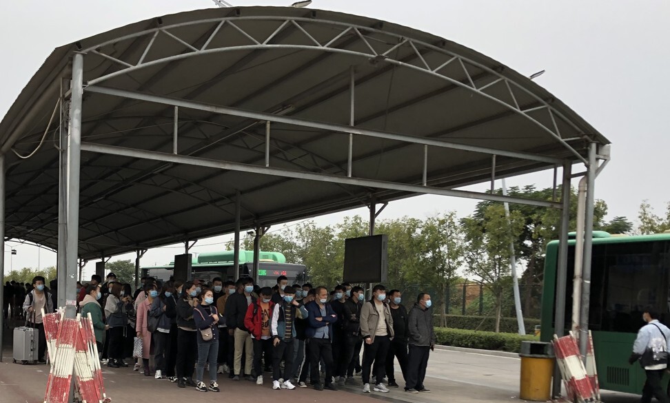 Outside one of Foxconn Technology Group’s recruitment centres in Zhengzhou, applicants who passed the interview process line up to be taken by bus to another site for physical examination. Photo: SCMP