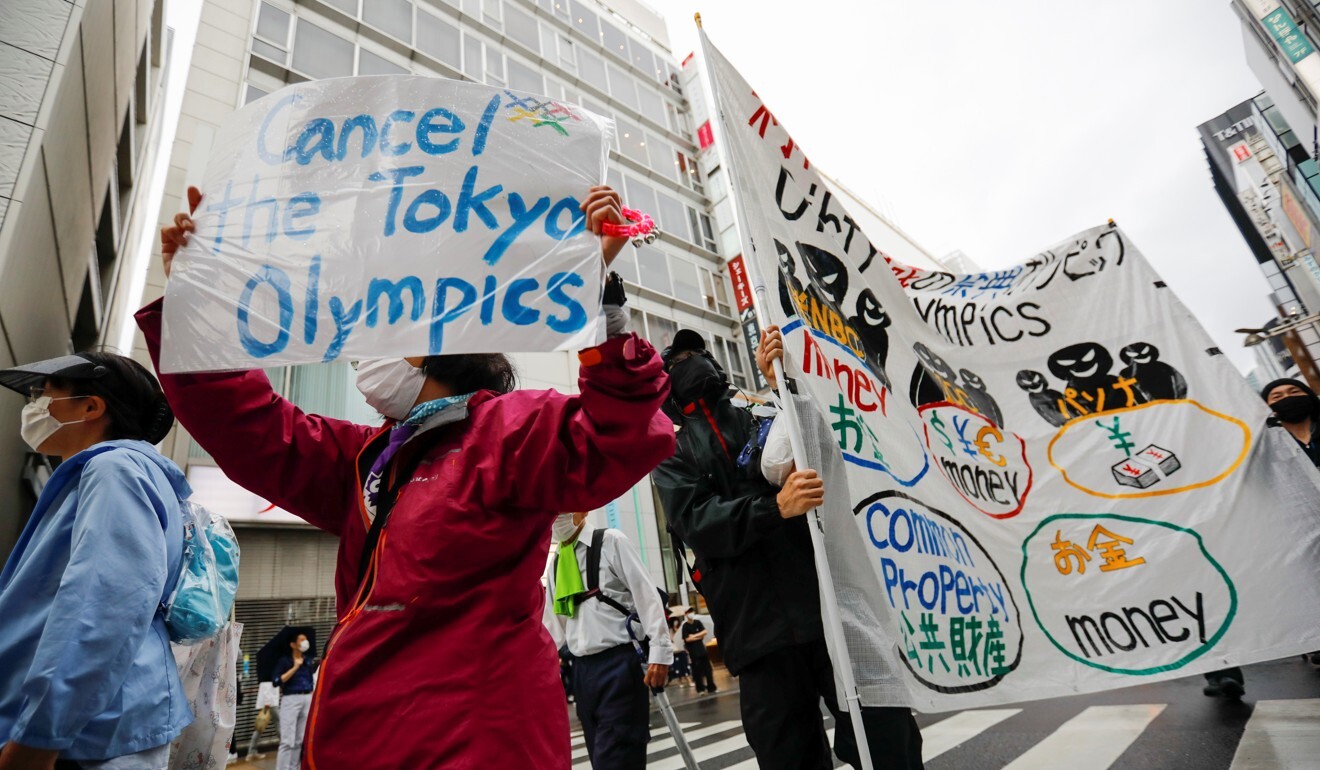 Protesters carry banners calling for the Olympics to be cancelled at a march held in Tokyo earlier this month. Photo: Reuters