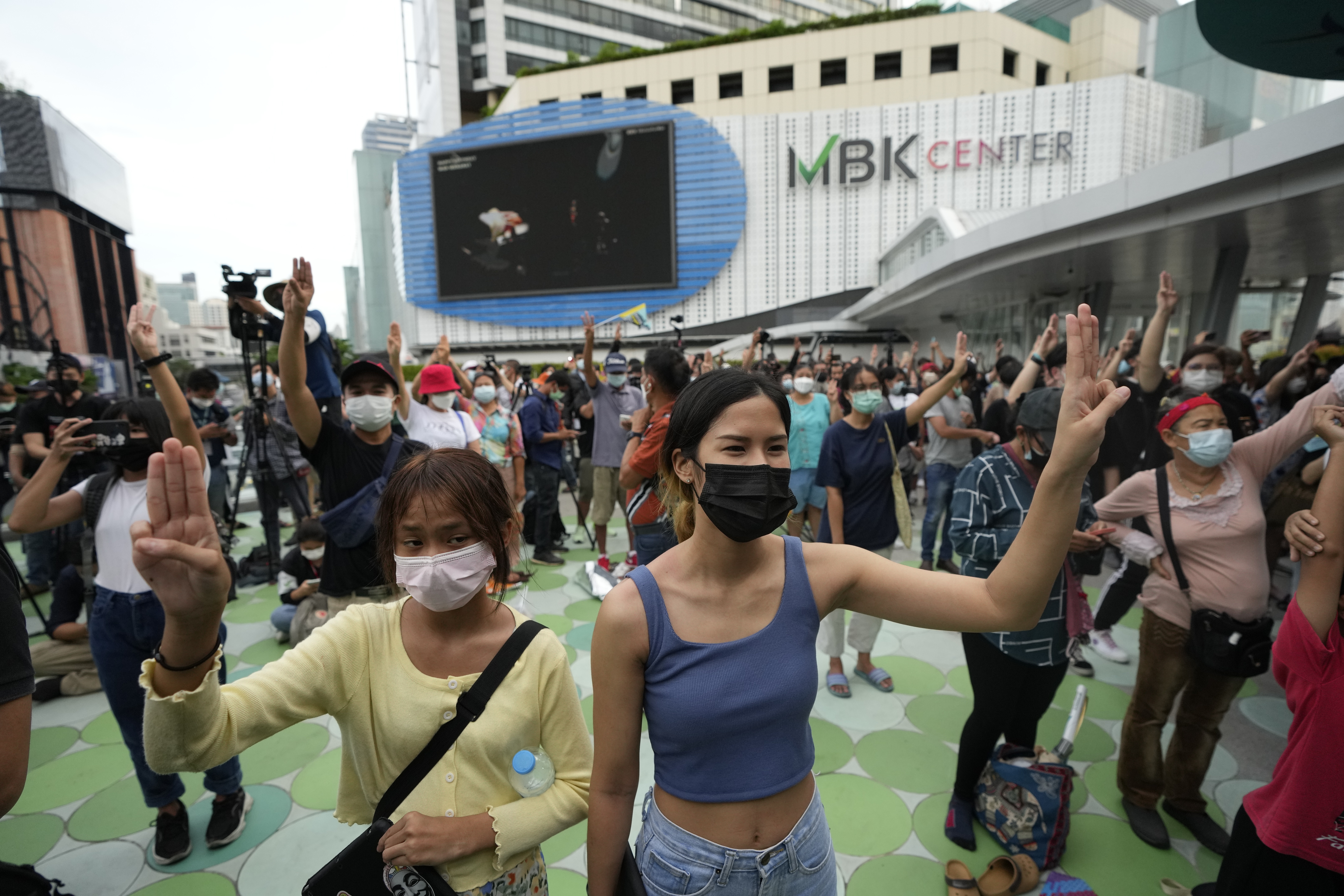 Pro-democracy supporters display the three-fingered symbol during a demonstration in Bangkok. photo: AP