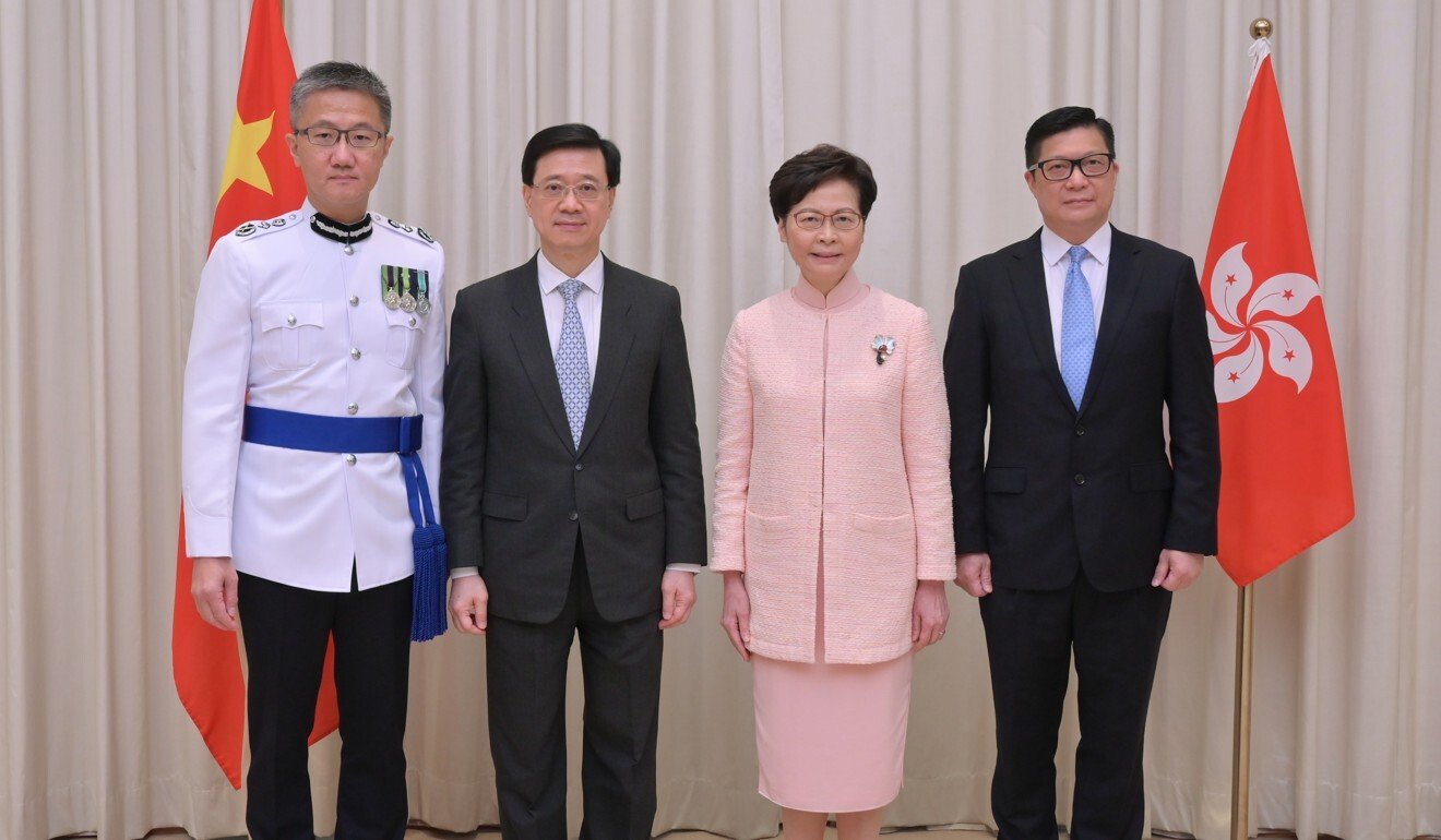 (From left) Raymond Siu, the new police chief, new No 2 official John Lee, Hong Kong leader Carrie Lam and former police commissioner Chris Tang, now the security minister. Photo: Handout