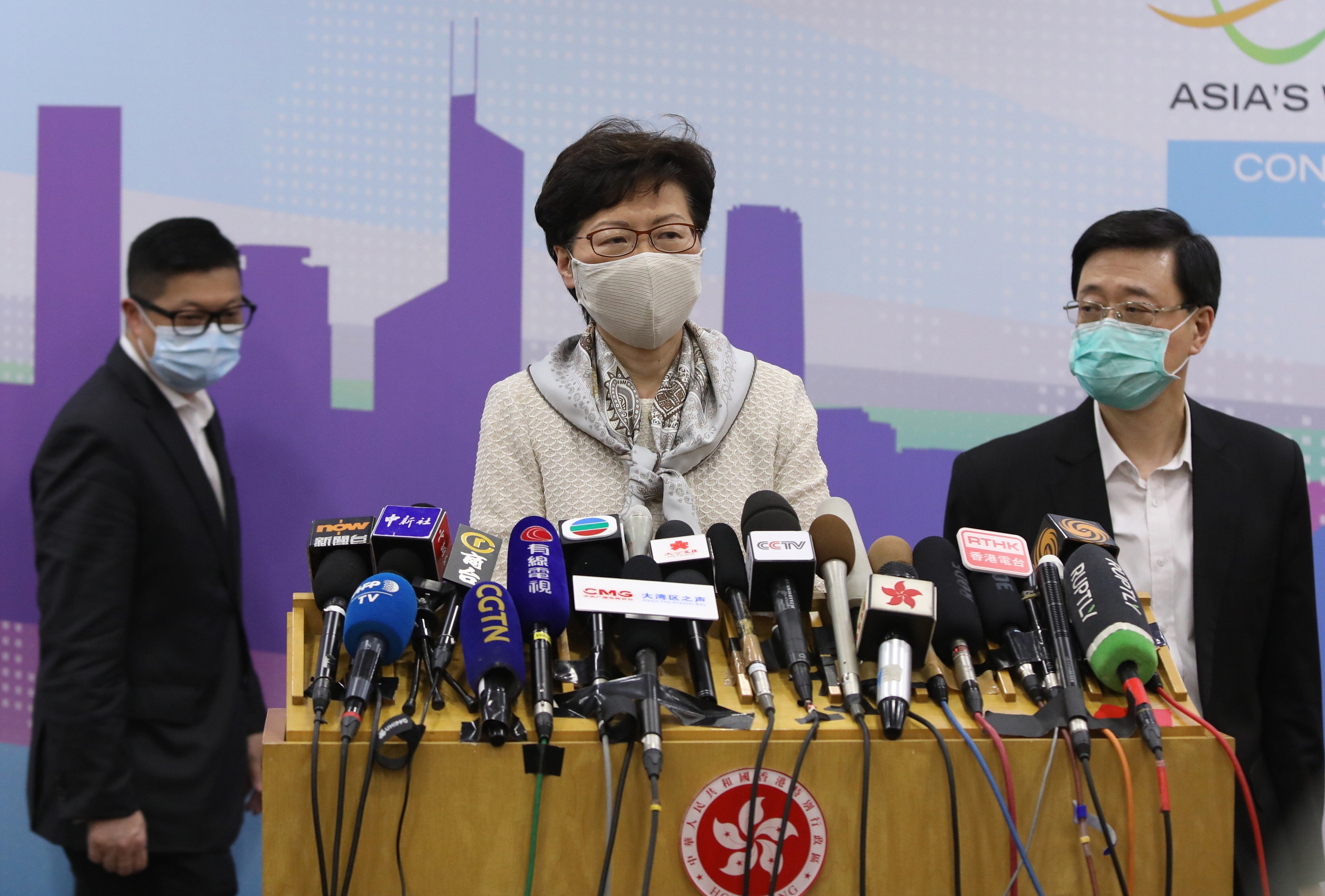 Carrie Lam with Chris Tang (left) and John Lee. Photo: Simon Song