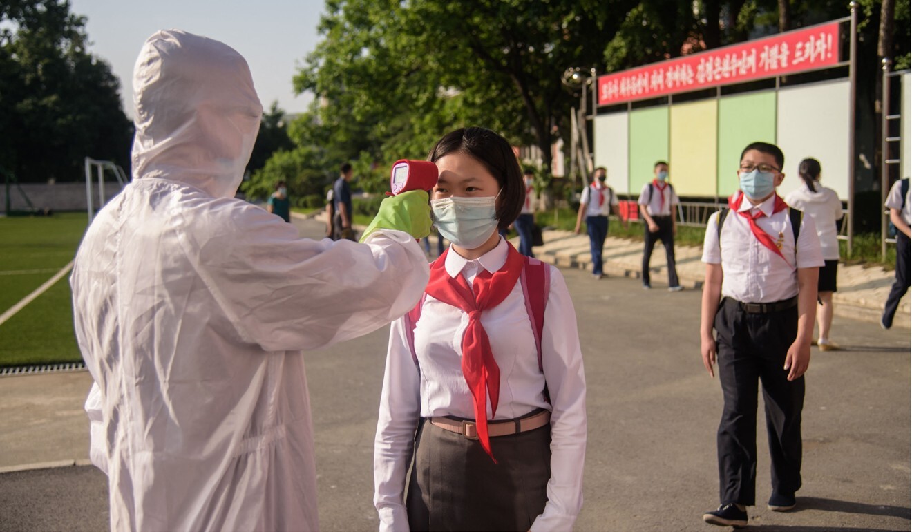 A pupil in Pyongyang has her temperature taken as part of anti-coronavirus measures. Photo: AFP