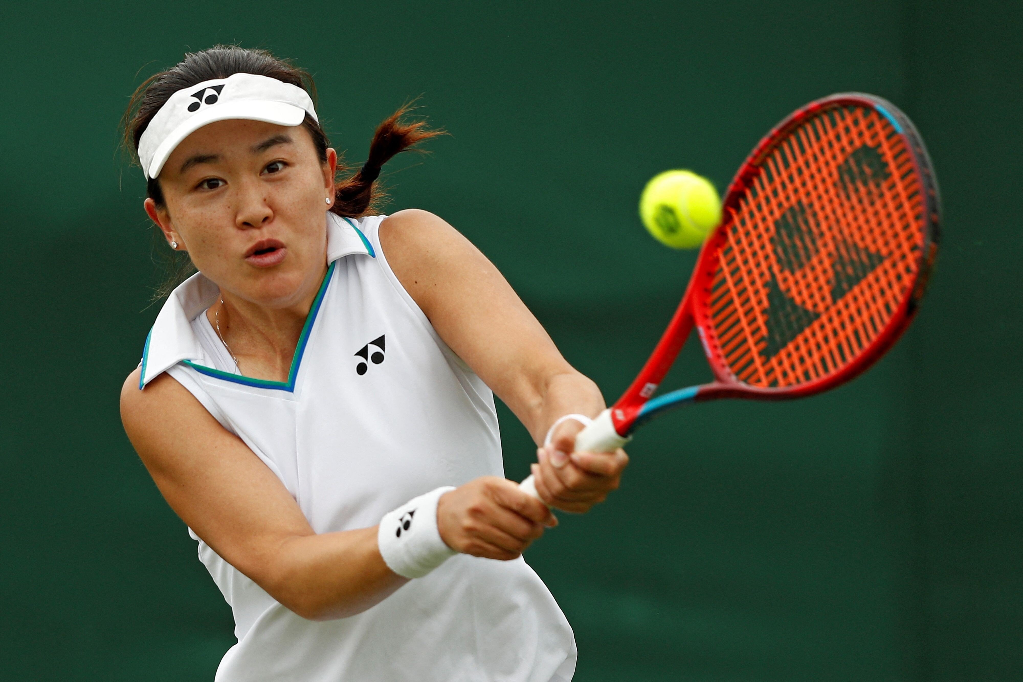 China's Zhu Lin returns against Germany's Mona Barthel on her way to winning their first round women’ singles match at Wimbledon. Photo: AFP