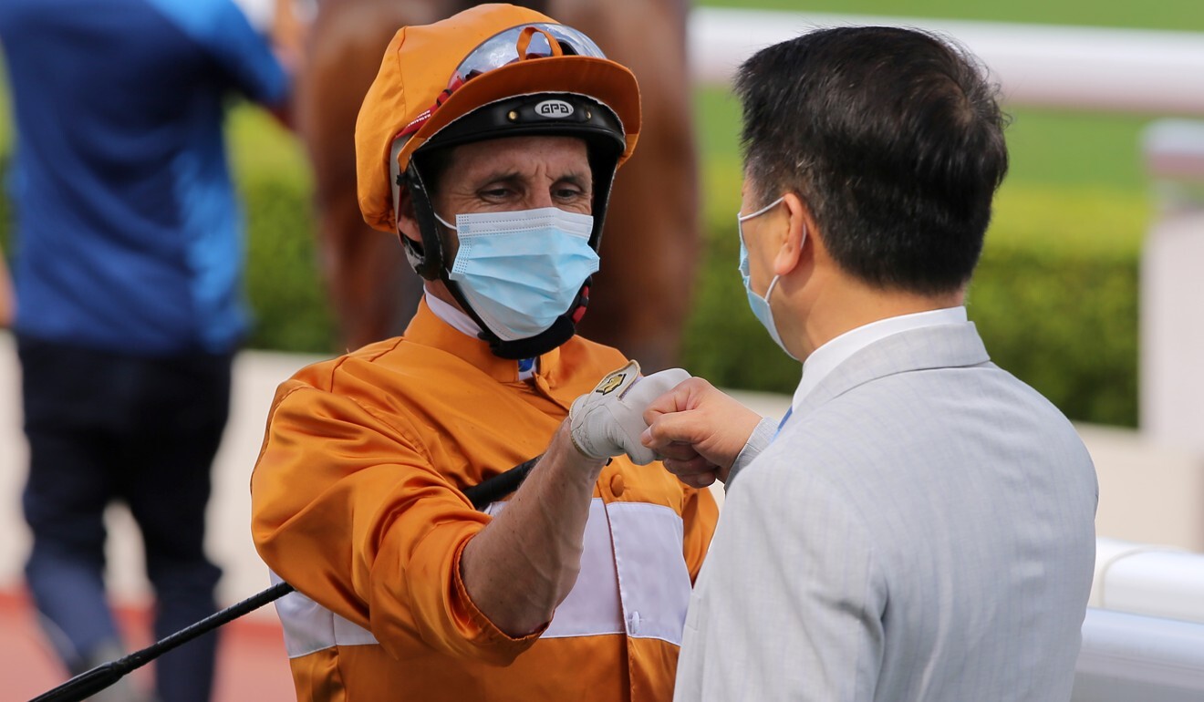 Jockey Neil Callan and trainer Ricky Yiu celebrate Excellent Chariot’s victory.