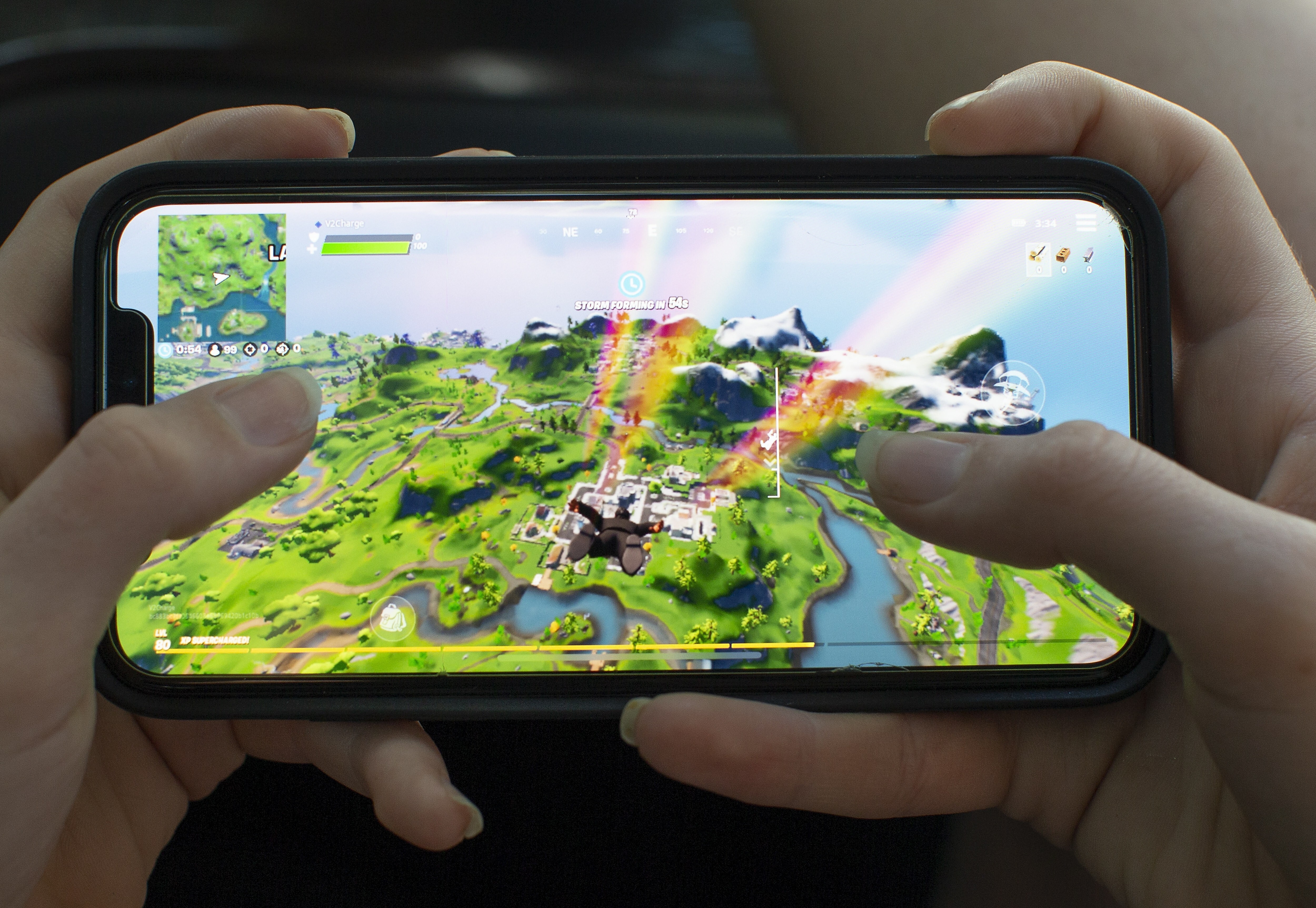 A teenage girl plays the video game Fortnite, on an Apple iPhone X in Billerica, Massachusetts, on August 24, 2020. Tencent owns nearly half of Epic Games, an investment now facing scrutiny in the US. Photo: EPA-EFE