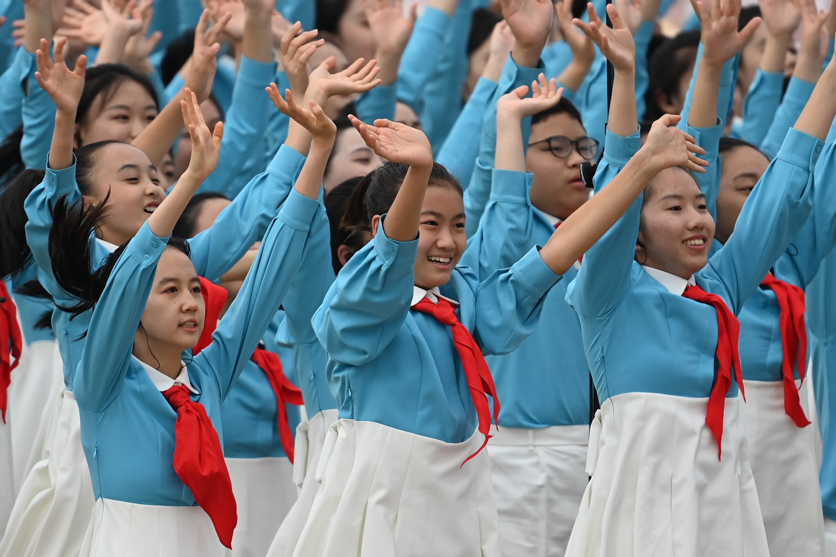 Choir members wave during the centenary celebration in Tiananmen Square on Thursday. Photo: Xinhua