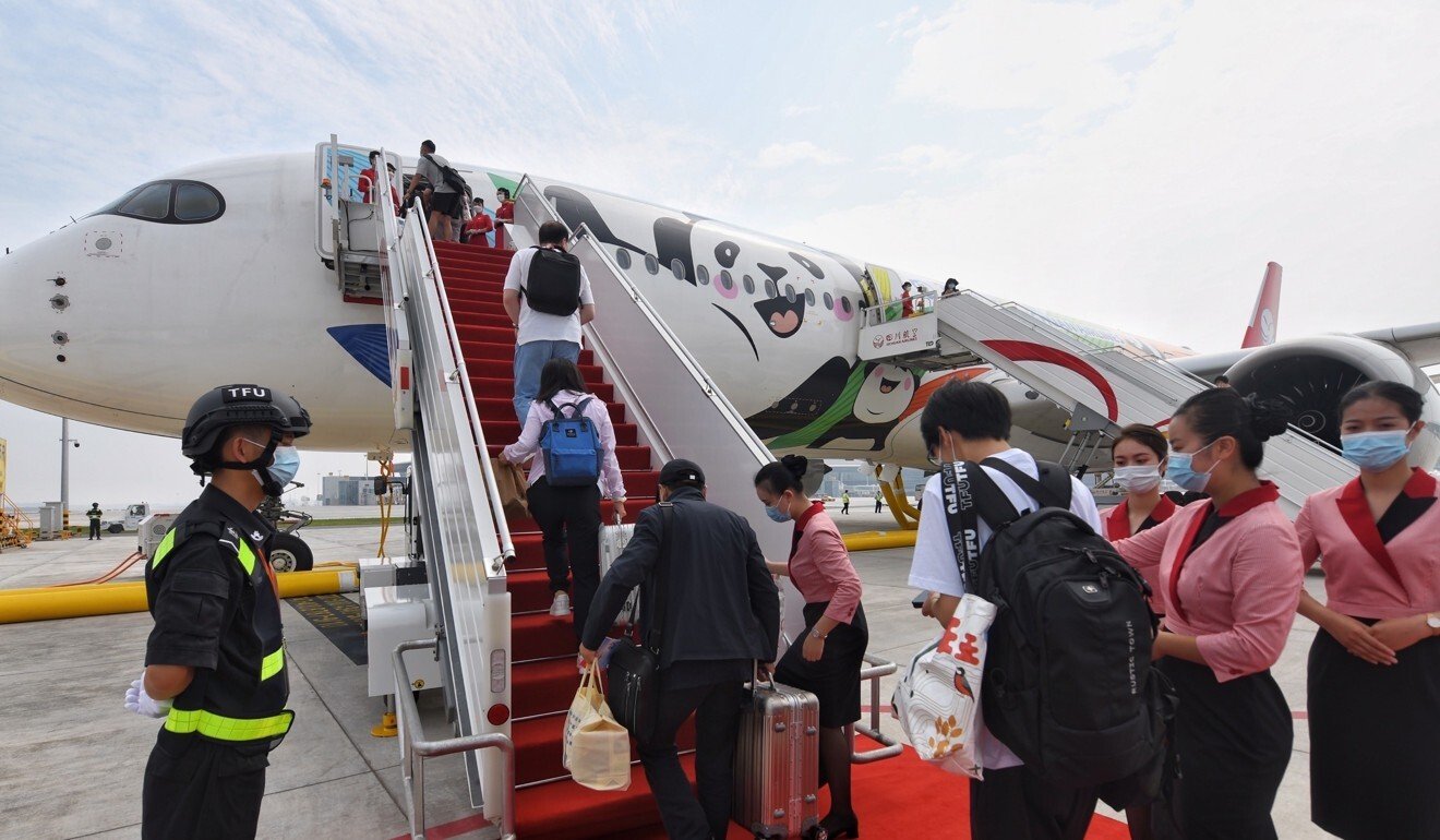 Passengers board a Sichuan Airlines flight to Beijing at the new airport on Sunday morning. Photo: Xinhua