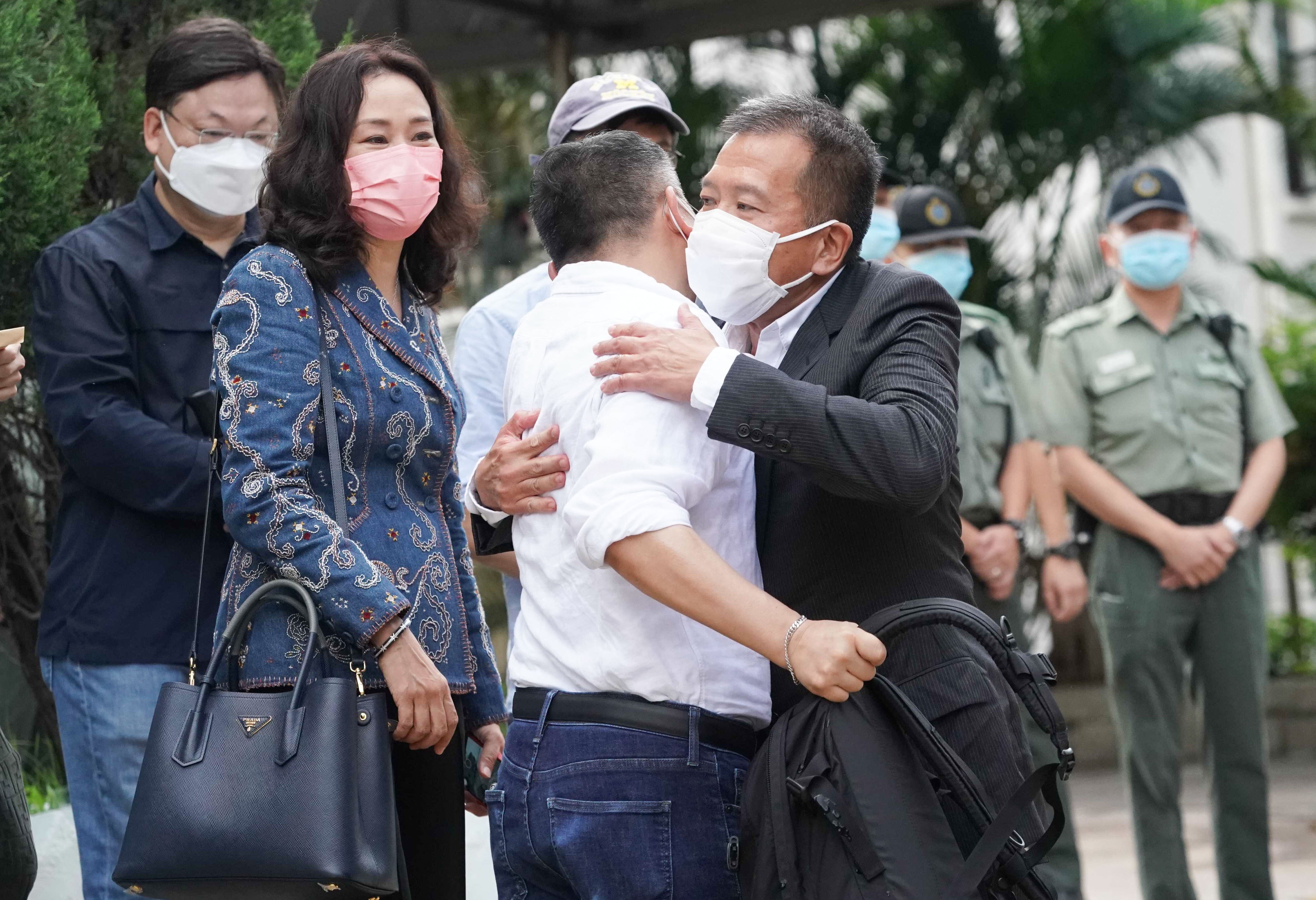 Peter Chan (in black suit) hugs a member of a group of people who had come to receive him after his release. Photo: Felix Wong