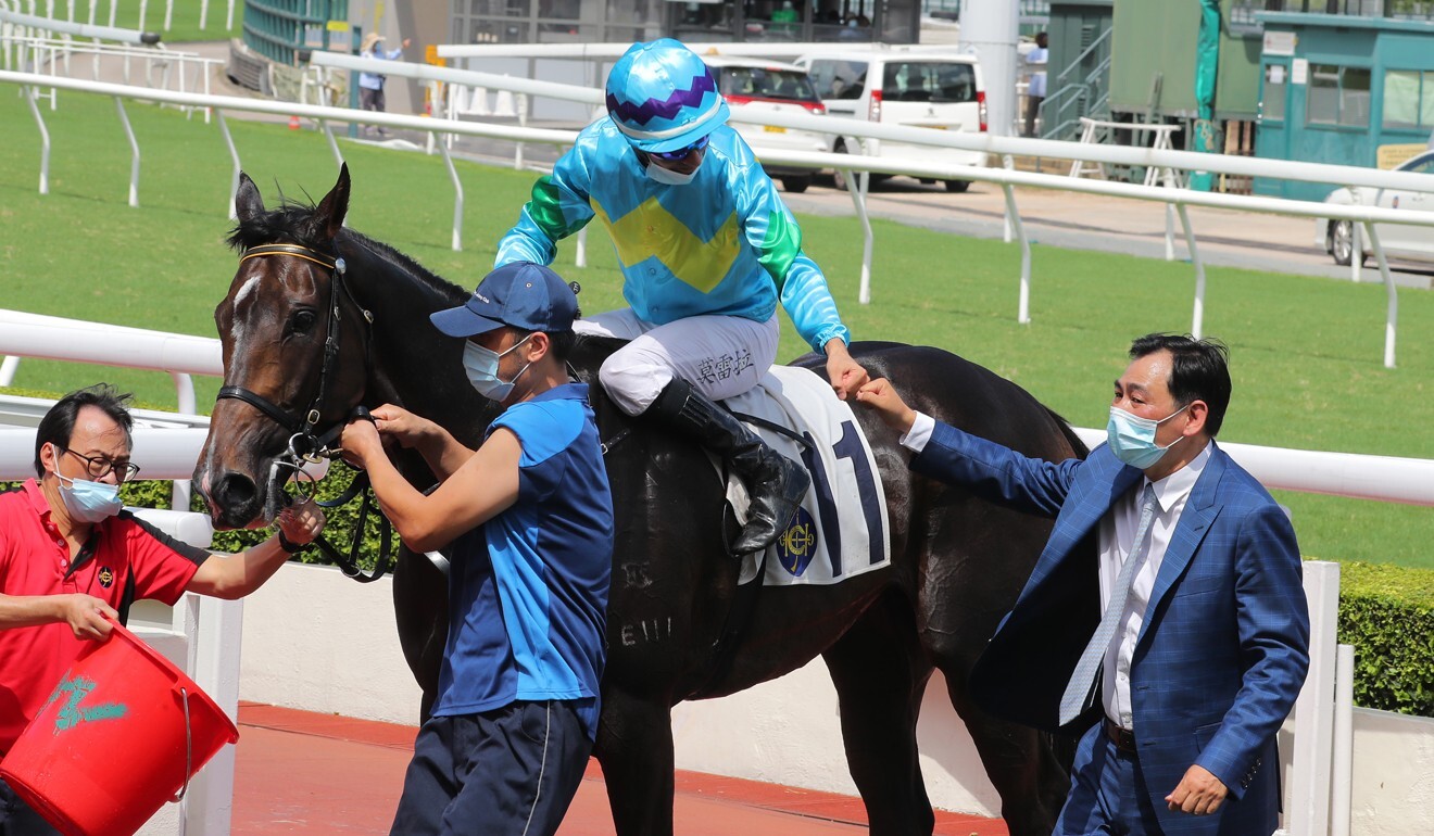 Trainer Michael Chang and jockey Joao Moreira celebrate Steel Win’s victory.
