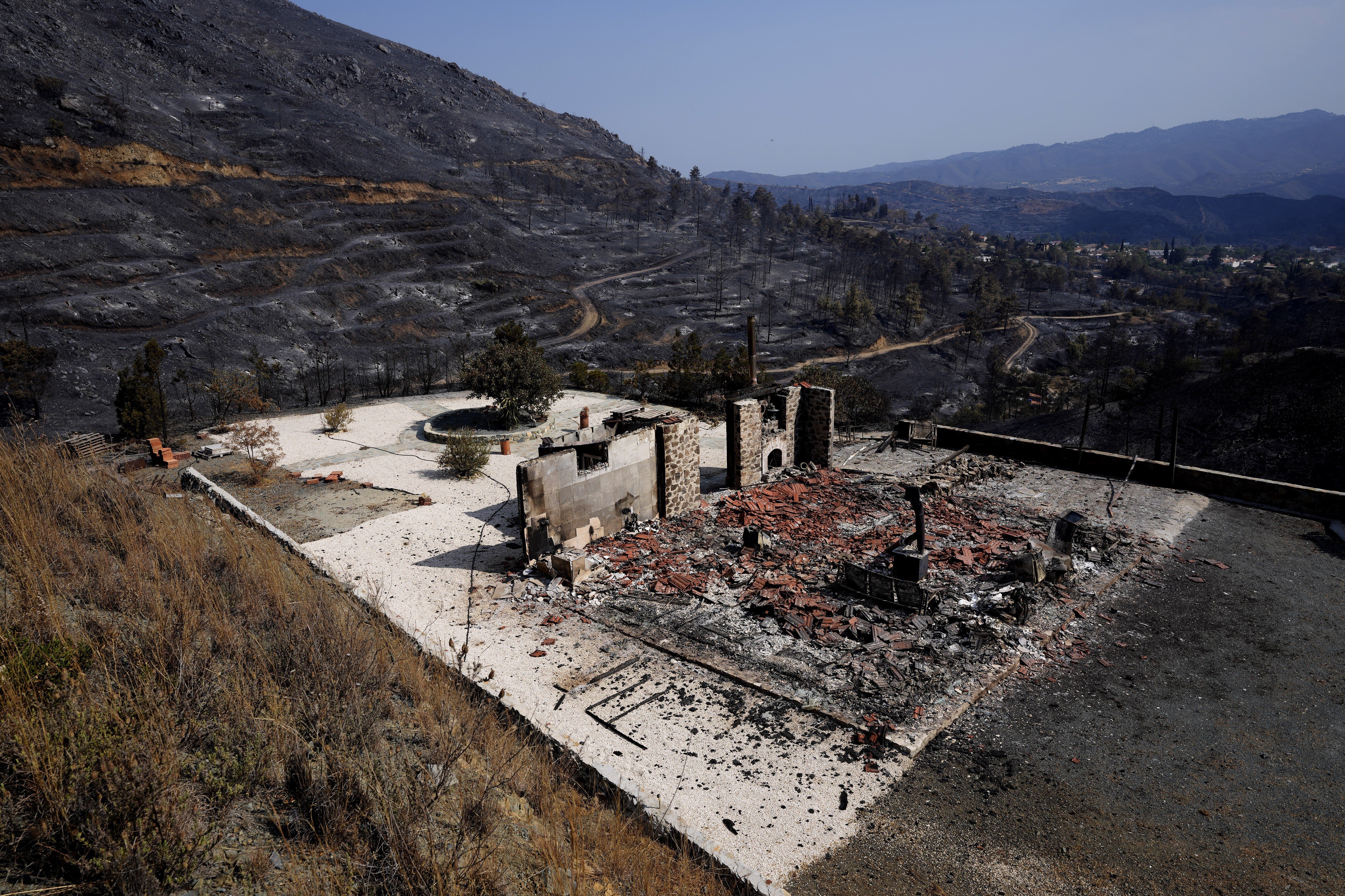 A burnt house outside the village of Ora, Cyprus, with the Larnaca mountain region in the background on Sunday. Photo: AP